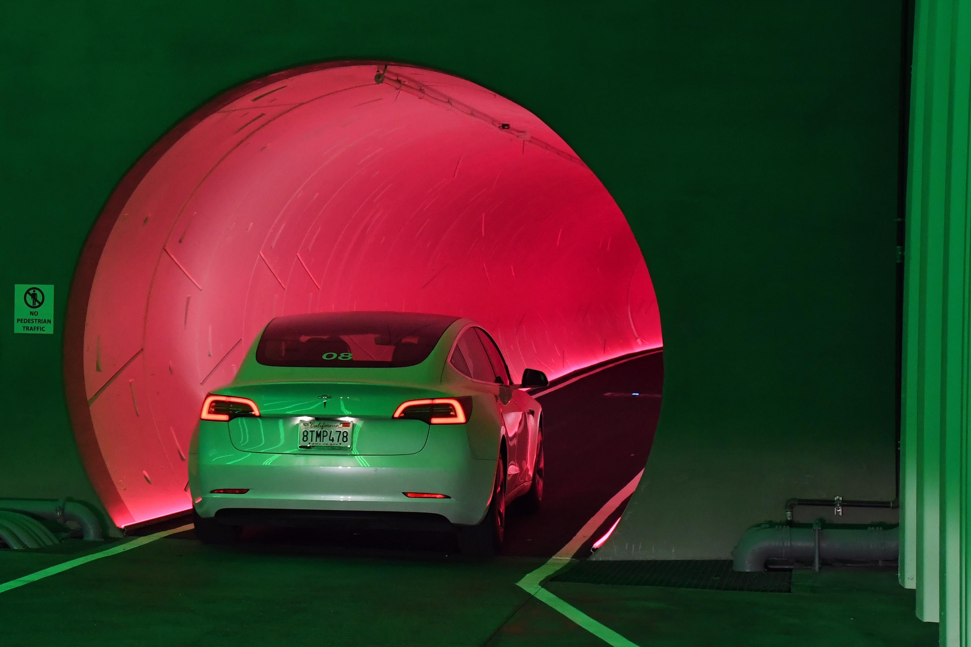 A Tesla car drives through a tunnel in the Central Station during a media preview of the Las Vegas Convention Center Loop on April 9, 2021 in Las Vegas, Nevada. 