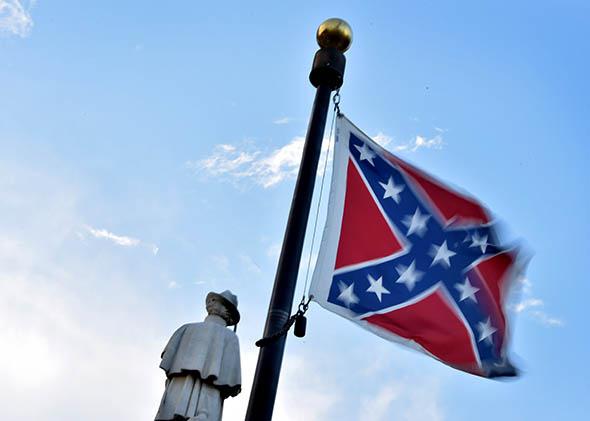 The Confederate flag is seen next to the monument of the victims,The Confederate flag is seen next to the monument of the victims of the Civil War in Columbia, South Carolina.