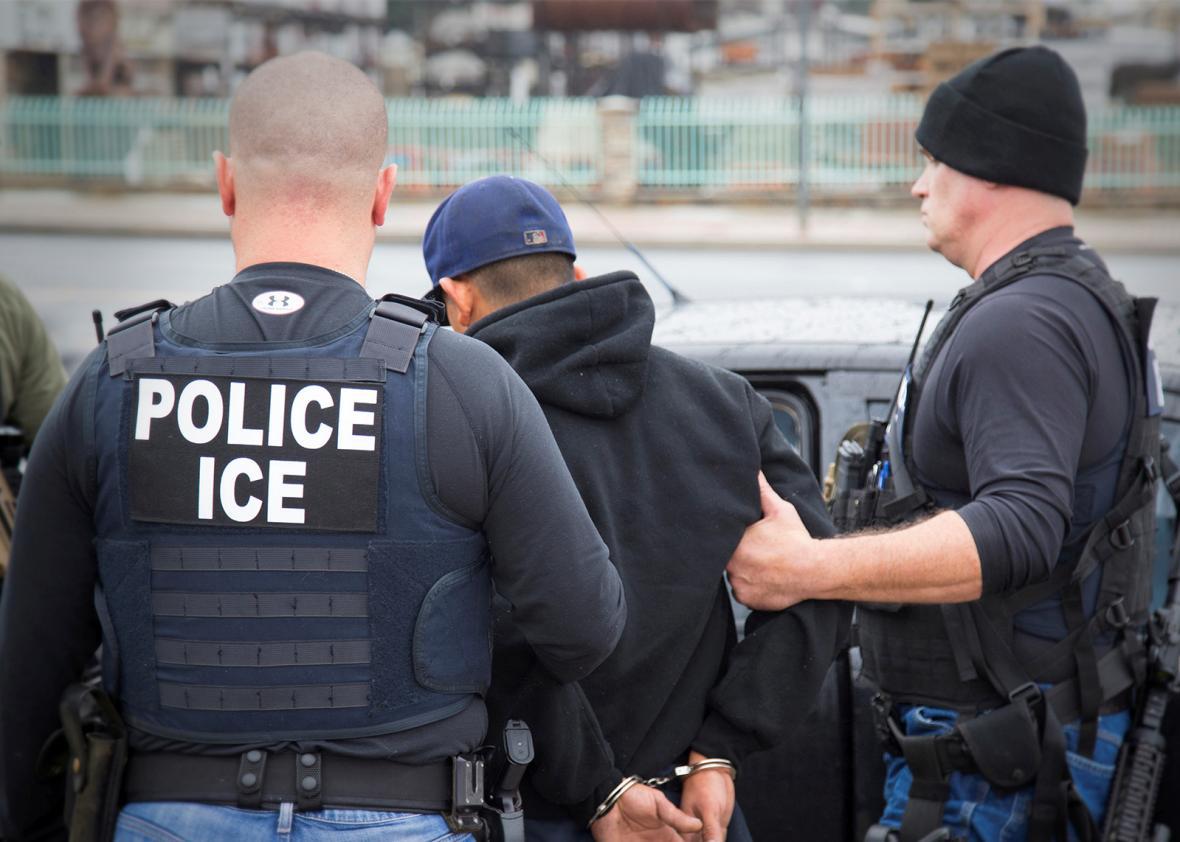 U.S. Immigration and Customs Enforcement (ICE) officers detain a,U.S. Immigration and Customs Enforcement (ICE) officers detain a suspect