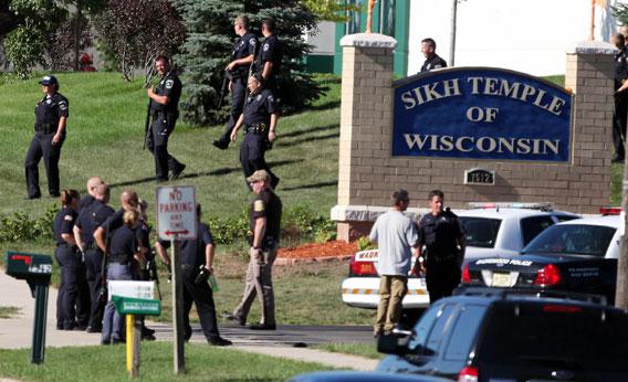Law enforcement personnel walk outside the Sikh Temple of Wisconsin where at least one gunman fired upon people at a service on August, 5, 2012 Oak Creek, Wisconsin.