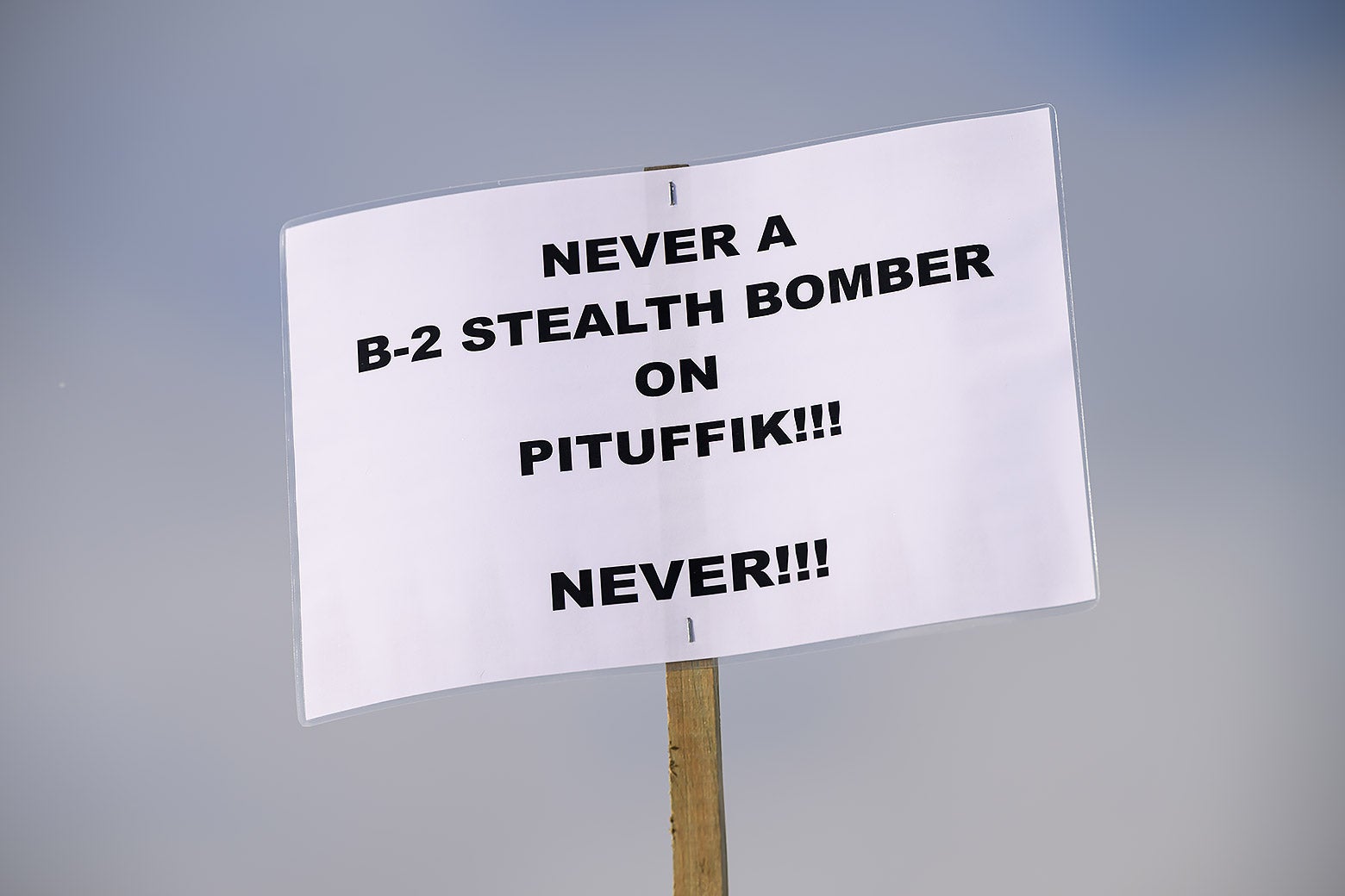 A sign by protestors demonstrating against an increased military presence at Pituffik space base in Greenland.