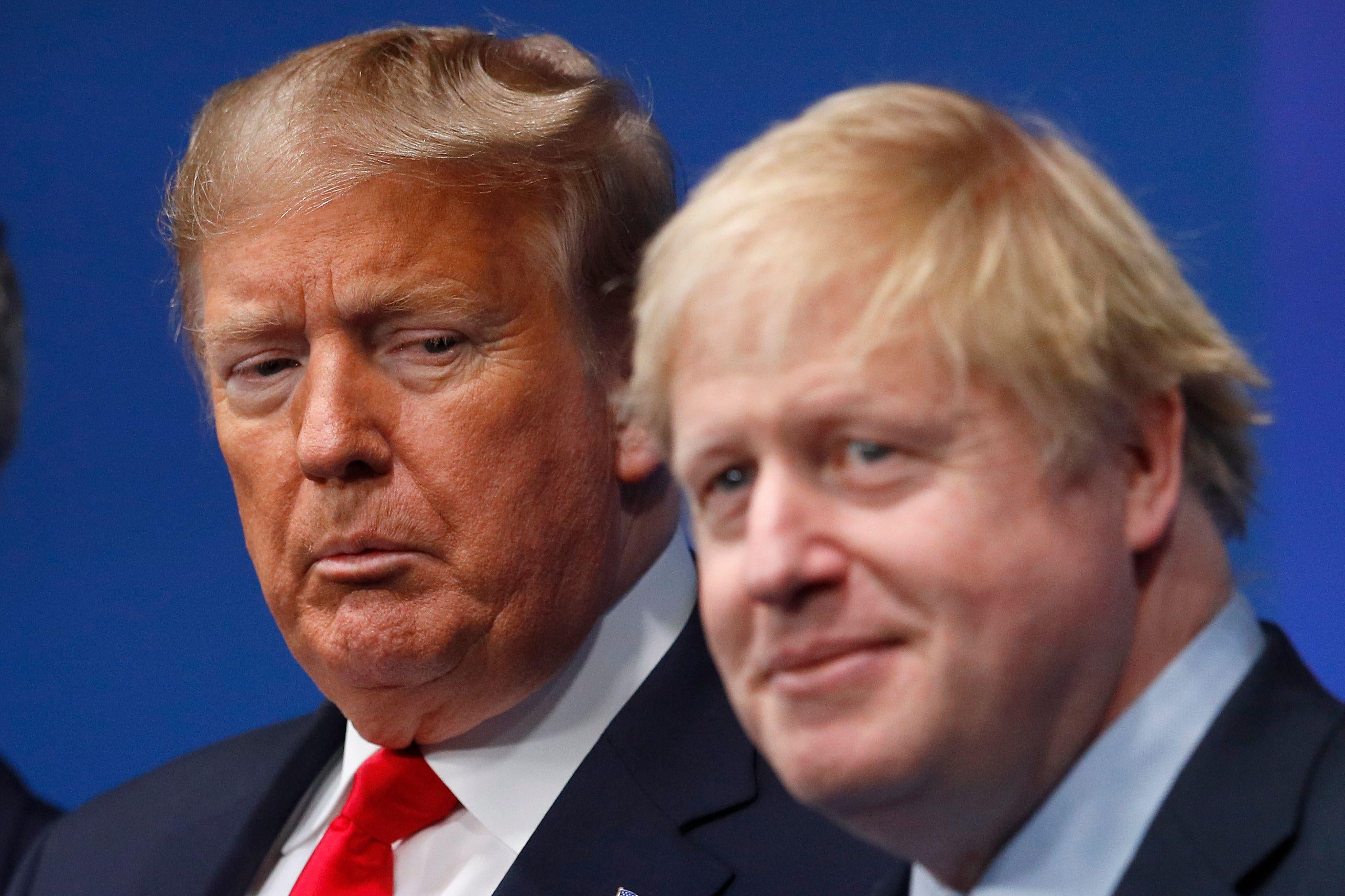 President Donald Trump makes a face while looking at British Prime Minister Boris Johnson.