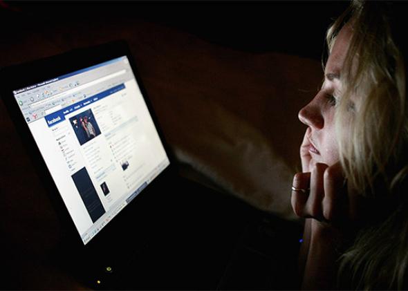 In this photo illustration a girl browses the social networking site Facebook in London, England. 