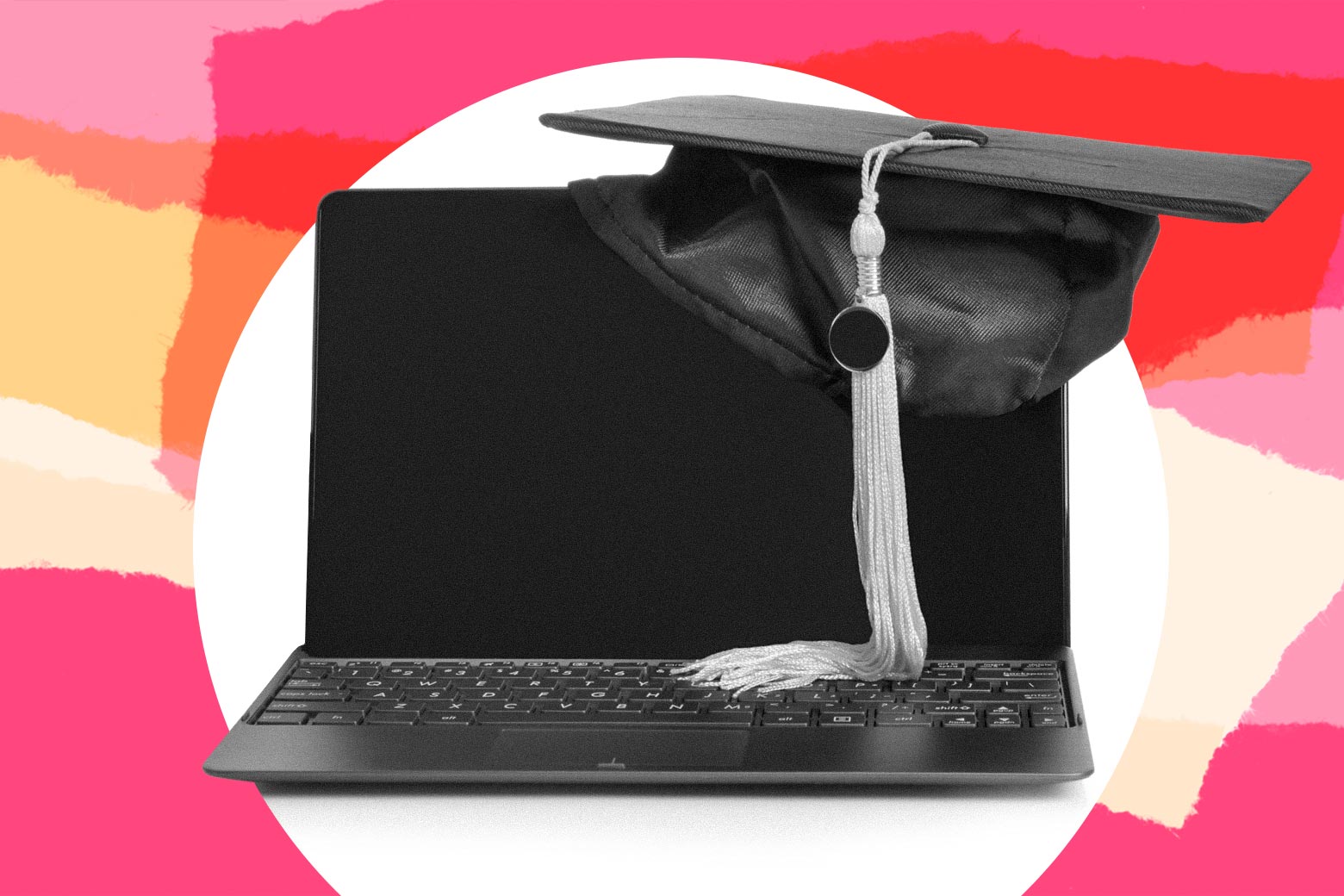 A laptop with a graduation cap on it.