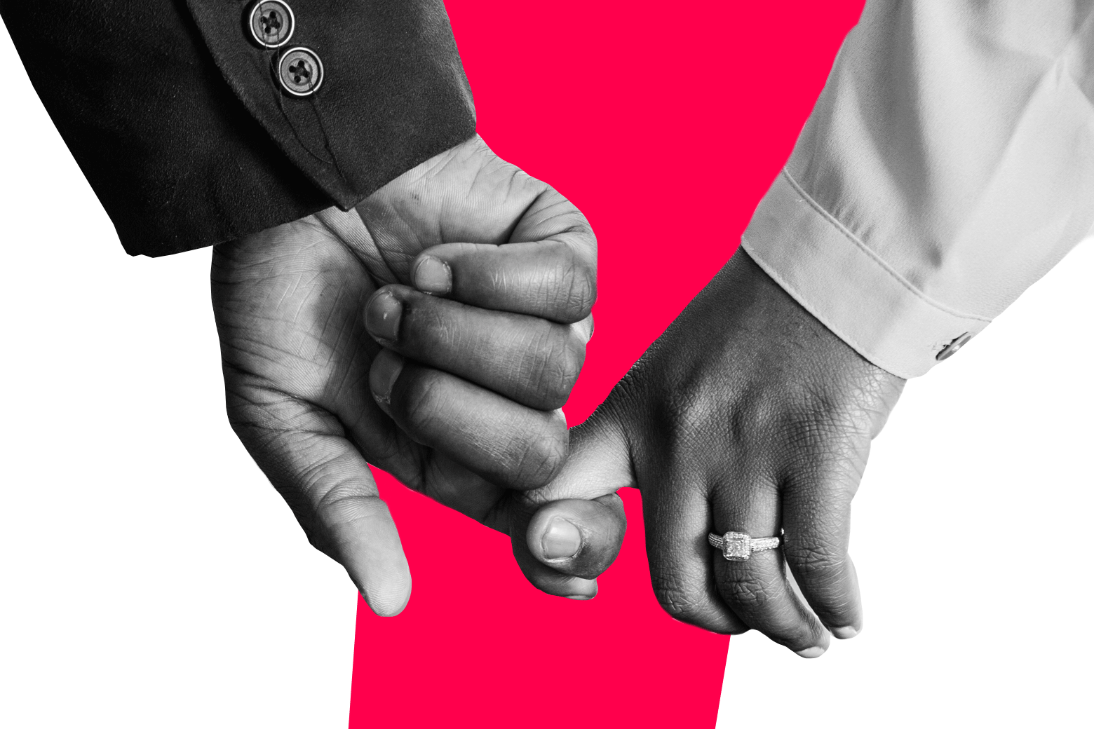 Man and woman with engagement ring loosely holding hands.