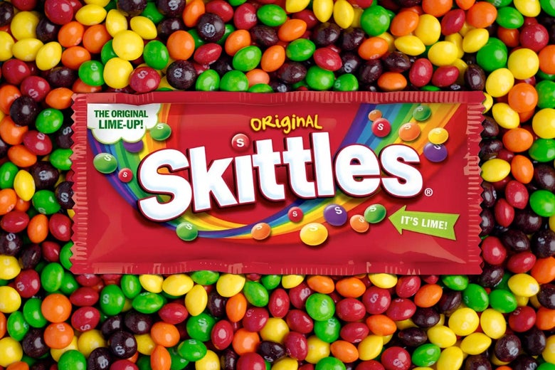 A packet of Skittles advertising the return of Lime floats on a background of individual Skittles candies. 