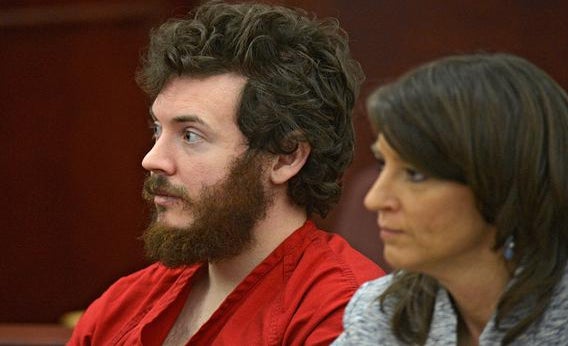 James Holmes, left, and defense attorney Tamara Brady appear in district court in Centennial, Colo. for his arraignment on March 12, 2013.