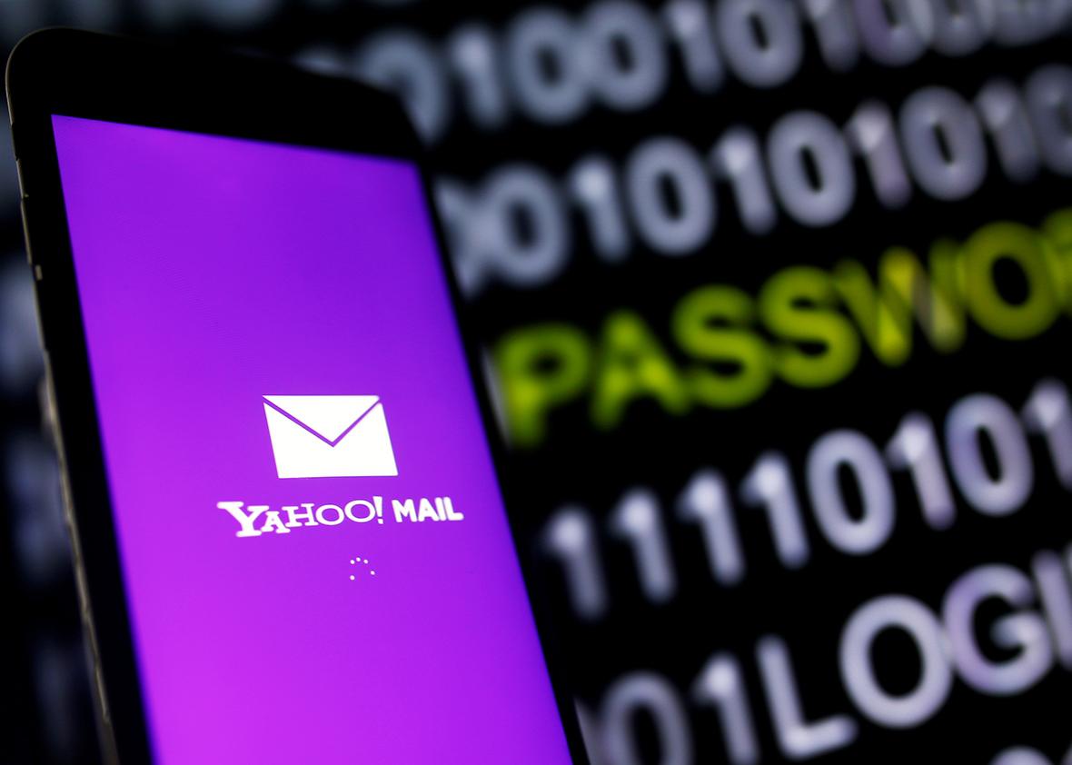 Yahoo Mail logo is displayed on a smartphone's screen in front of a code in this illustration taken in October 6, 2016.