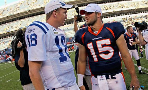 Quarterback Peyton Manning #18 of the Indianapolis Colts and quarterback Tim Tebow #15 of the Denver Broncos meet