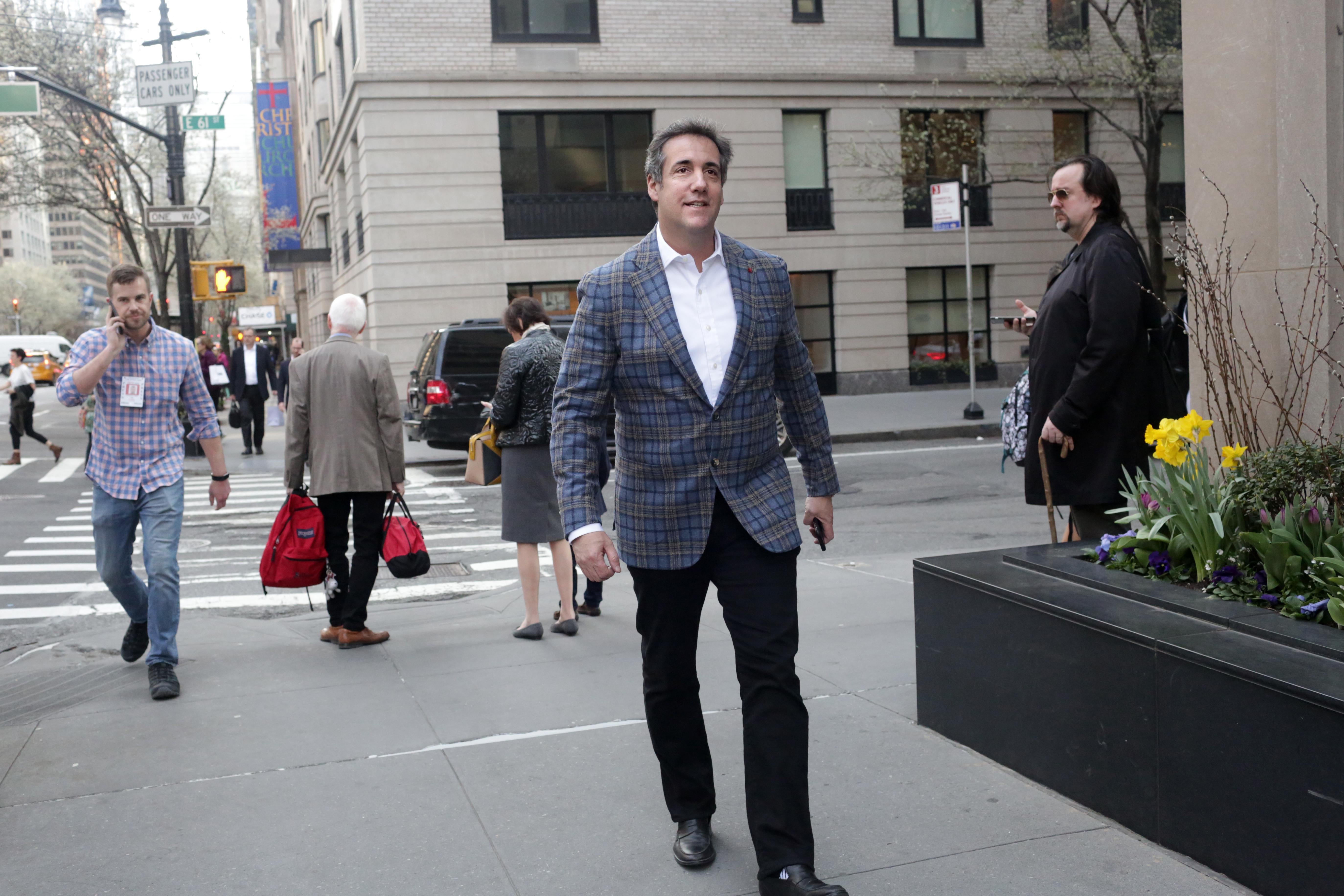 Michael Cohen walks on the New York City sidewalk.