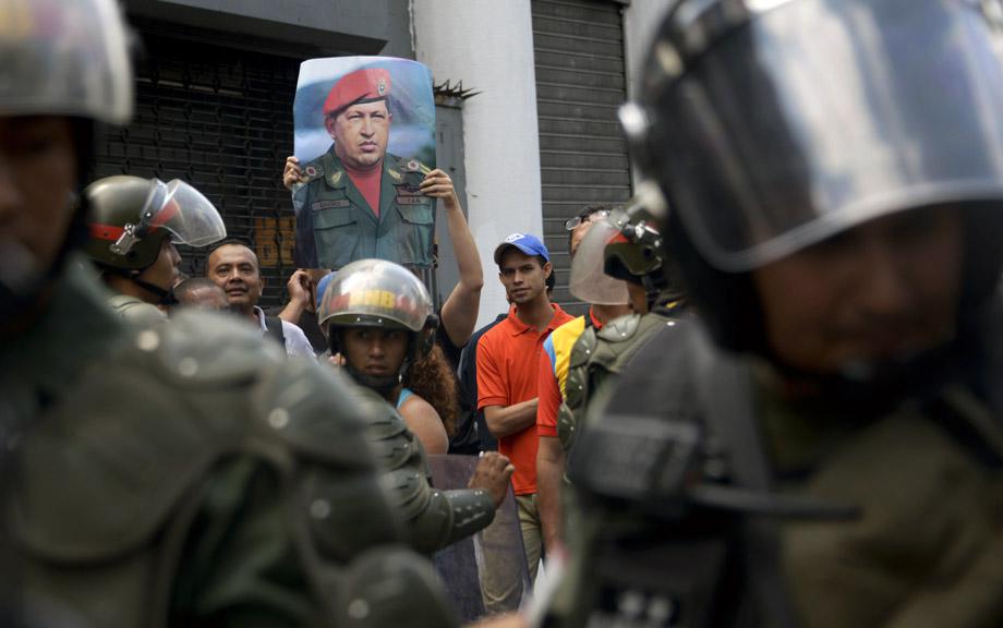 Supporters of Venezuelan President Nicolas Maduro hold a protest against opposition leader Leopoldo Lopez -- who was arrested on the eve on charges of homicide and inciting violence-- on February 19, 2014, in Caracas. 