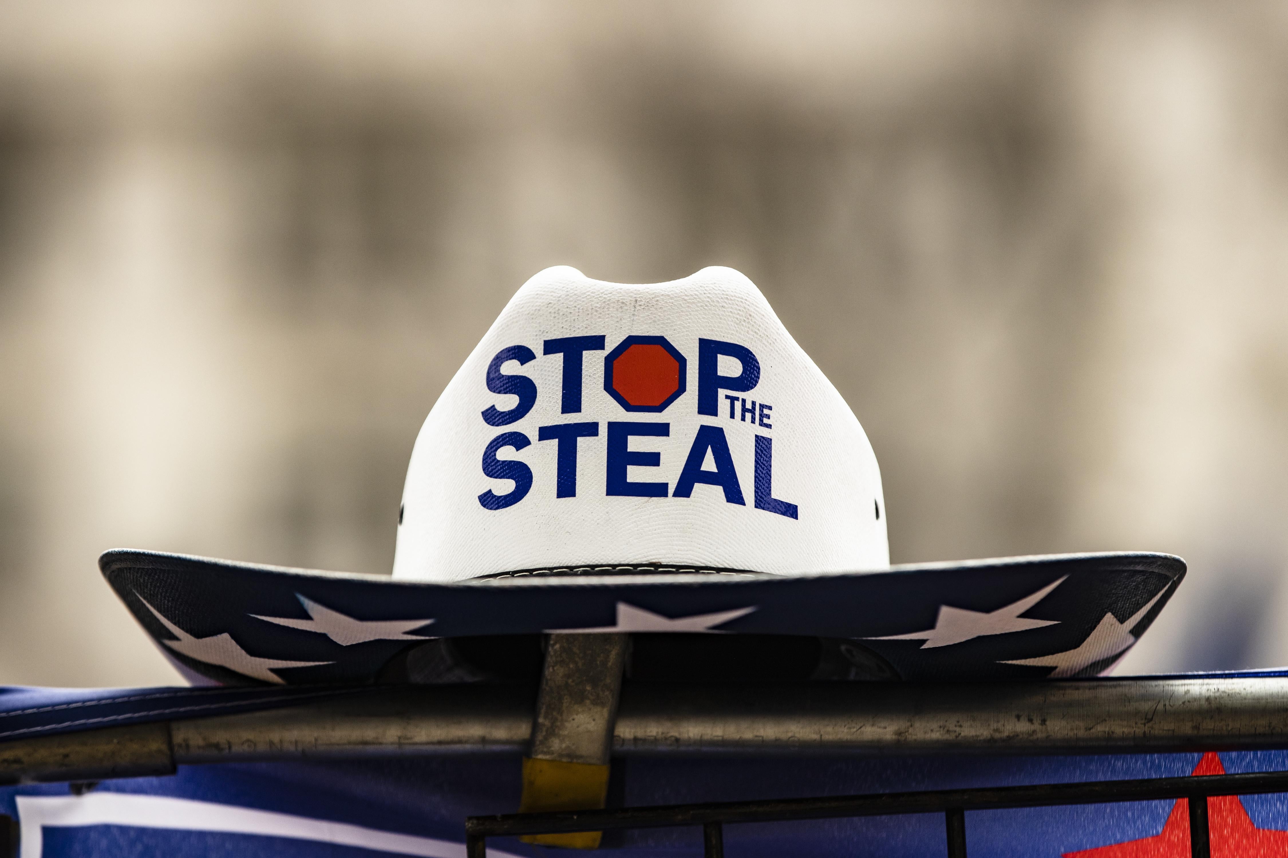 A cowboy hat with Stop the Steal on one side and Team Trump on the other is for sale at a rally.