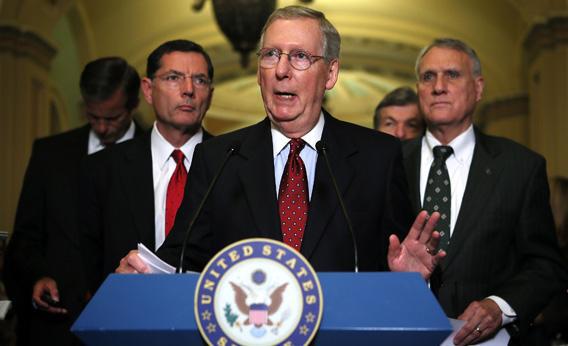 Sen. Mitch McConnell (R-KY), center, speaks to members of the media.