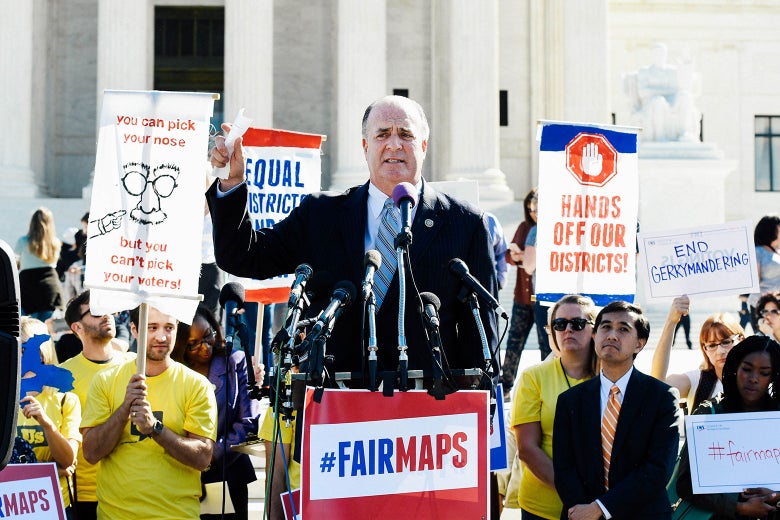 Dan Kildee stands at a podium that says, "#FairMaps."