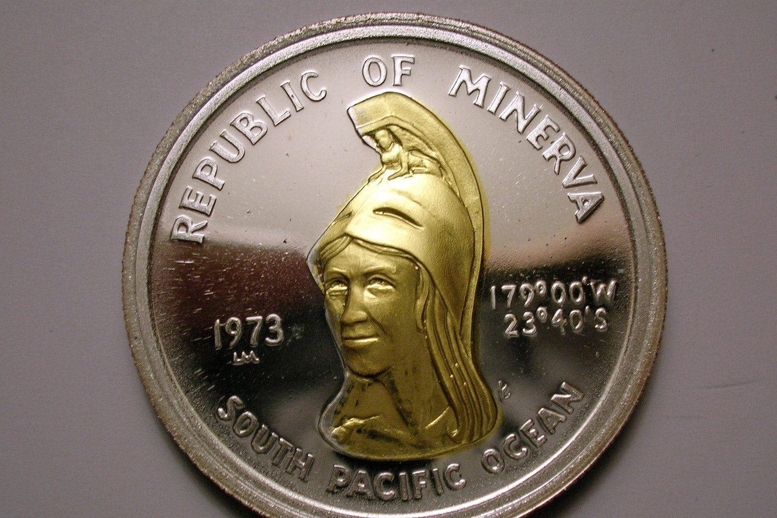 A Minerva coin depicting a golden woman in a helmet