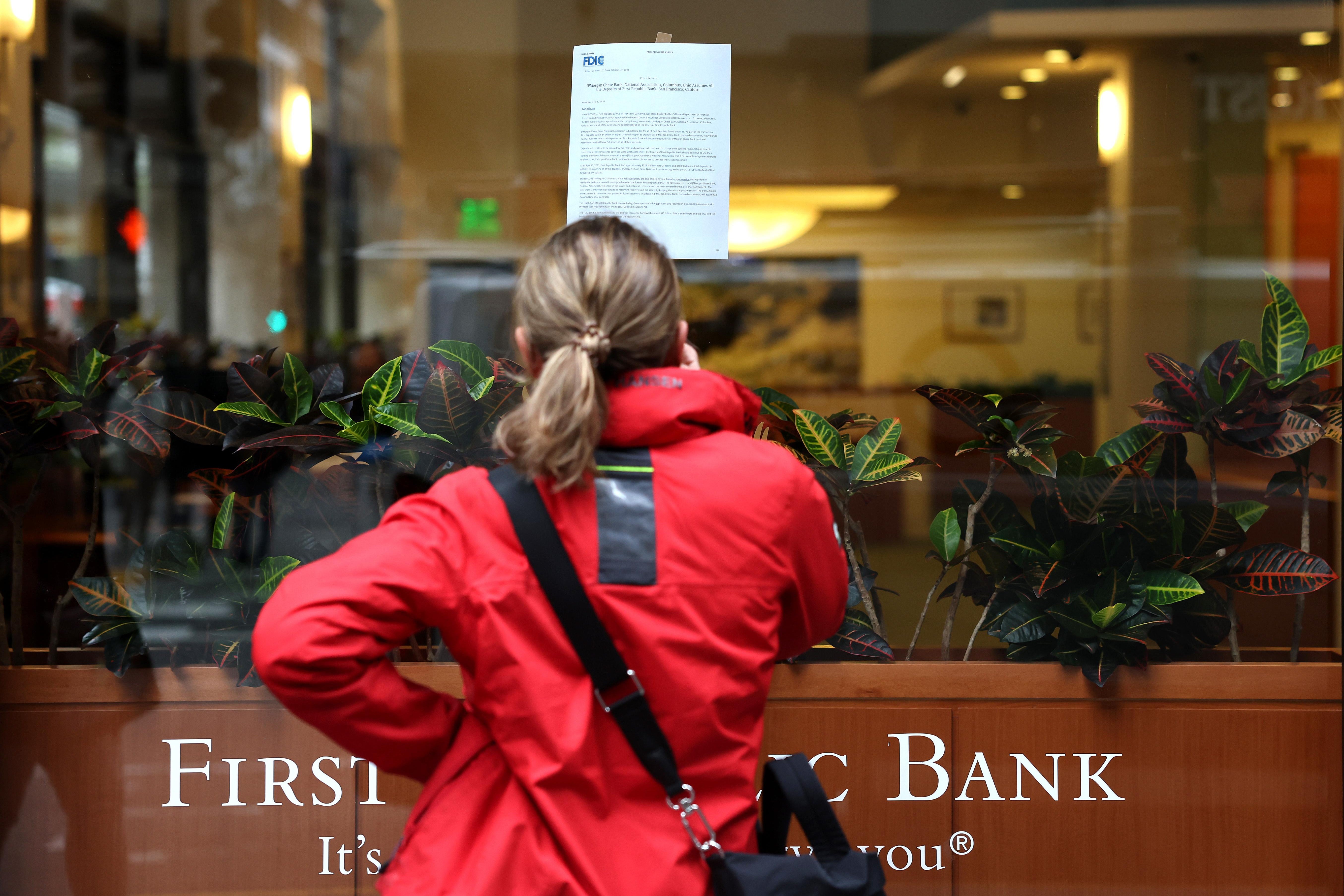 SAN FRANCISCO, CALIFORNIA - MAY 01: A passerby stops to read a posted announcement from the FDIC about the seizure of First Republic Bank and sale to JPMorgan Chase on May 01, 2023 in San Francisco, California. Federal Regulators seized troubled lender First Republic Bank on Monday and sold all of its deposits and most of its assets to JPMorgan Chase. First Republic becomes the second largest bank in U.S. history to fail since Washington Mutual failed in 2008. (Photo by Justin Sullivan/Getty Images)