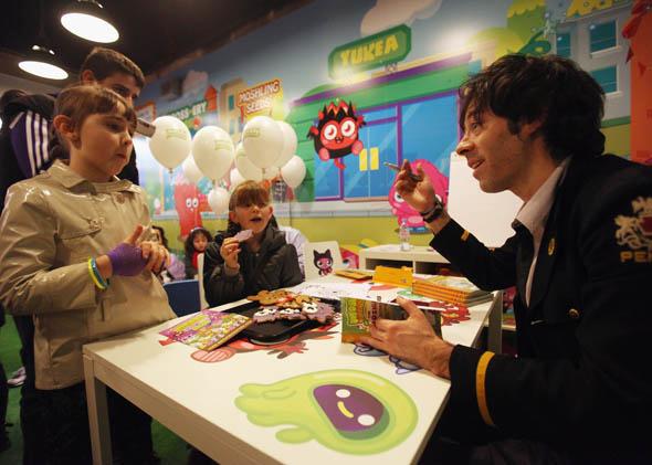 Michael Acton-Smith (R), the CEO of Mind Candy, meets fans of Moshi Monsters in a pop-up shop selling merchandise from the children's online game in February 2011 in London, England. 