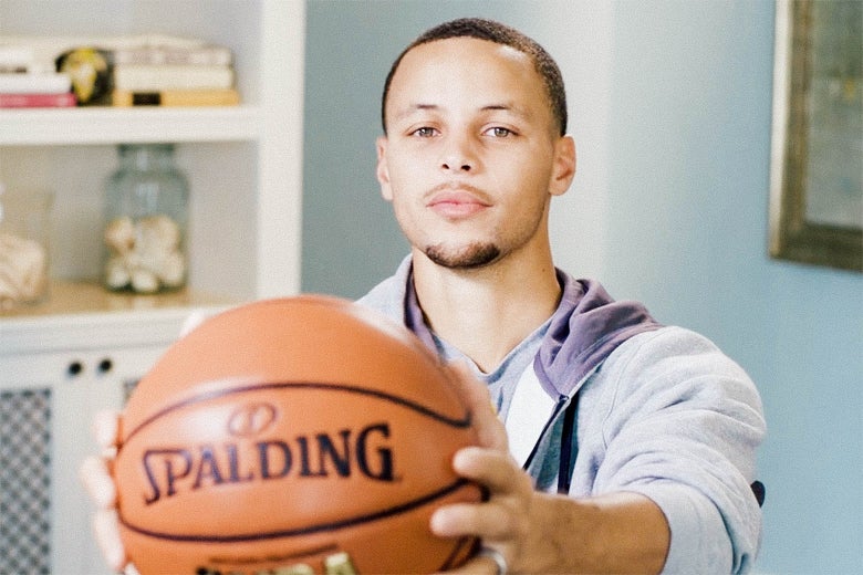 Stephen Curry holding a basketball.