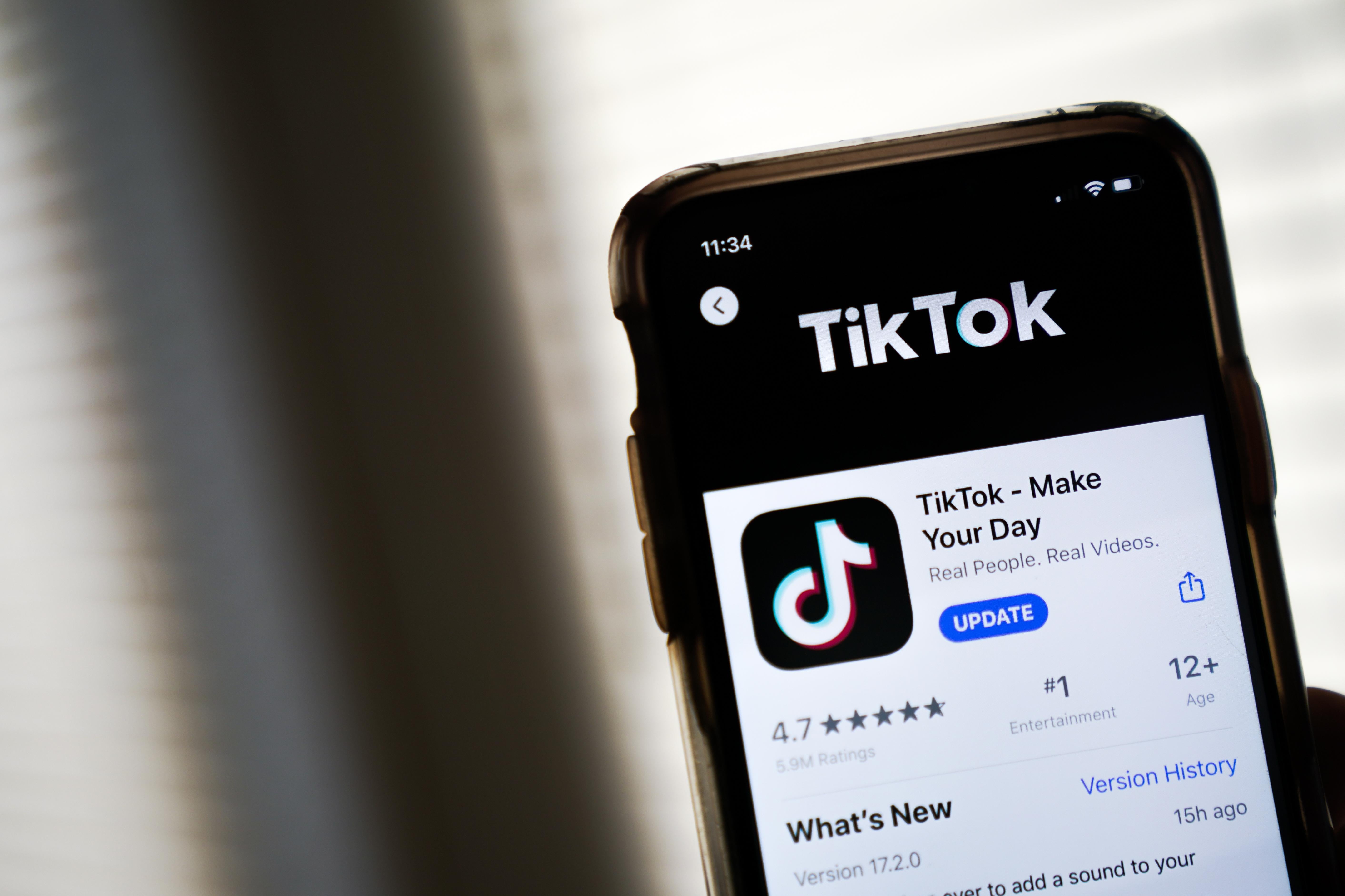 An iPhone screen displays TikTok's entry on the App Store.