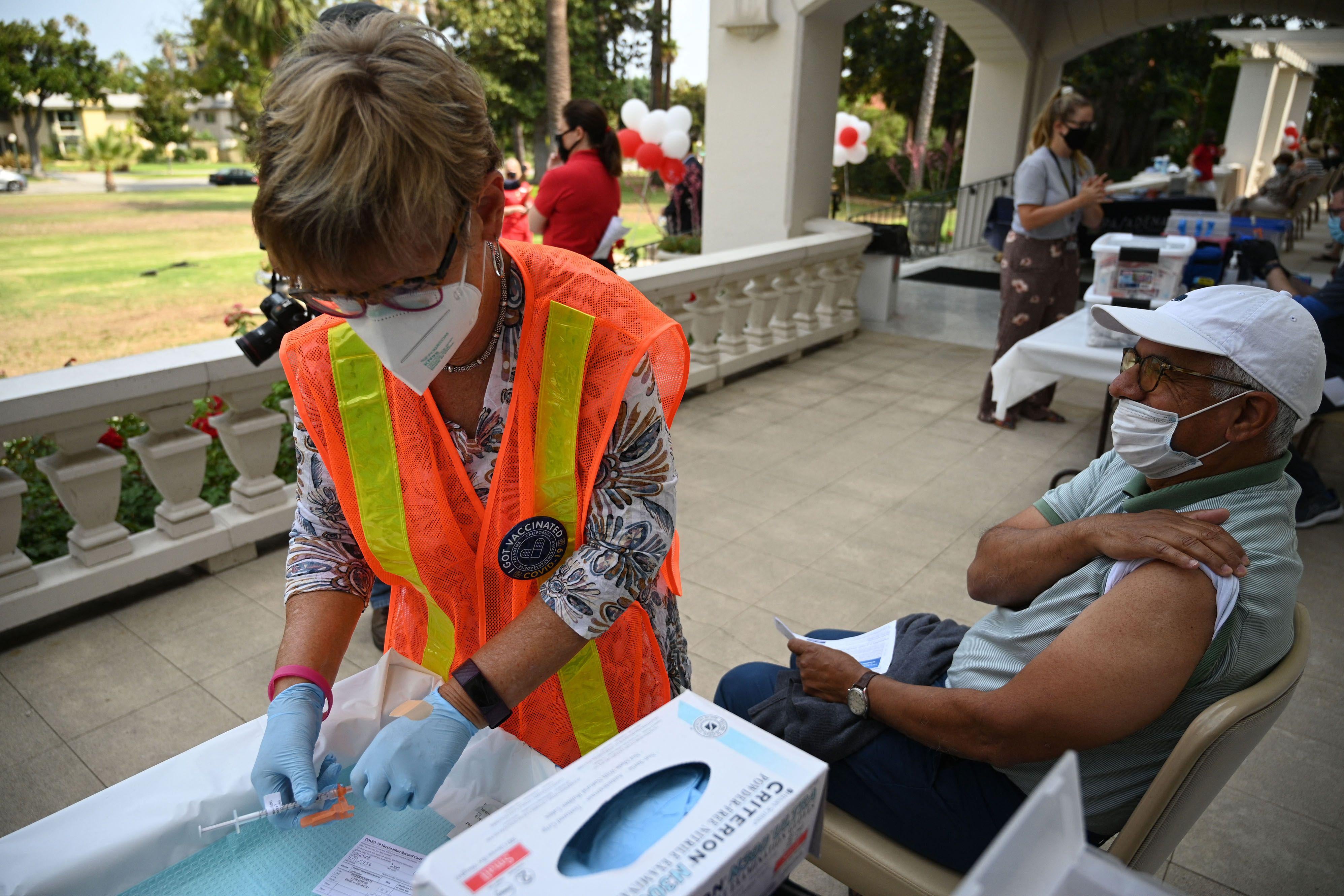 A nurse prepares a booster shot of the Pfizer vaccine at a clinic in Pasadena, California, on August 19.