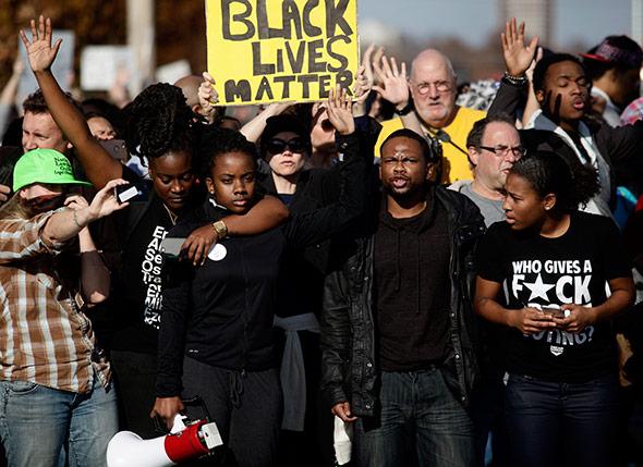 Demonstrators protest the shooting death of Michael Brown.