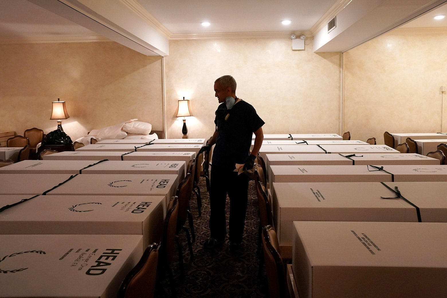 Funeral Director Omar Rodriguez looks over caskets of bodies at the Gerard J. Neufeld funeral home during the outbreak of the coronavirus disease (COVID-19) in Queens, New York on April 26.