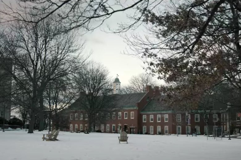 A snow-covered lawn at Pembroke, with a couple chairs on it.