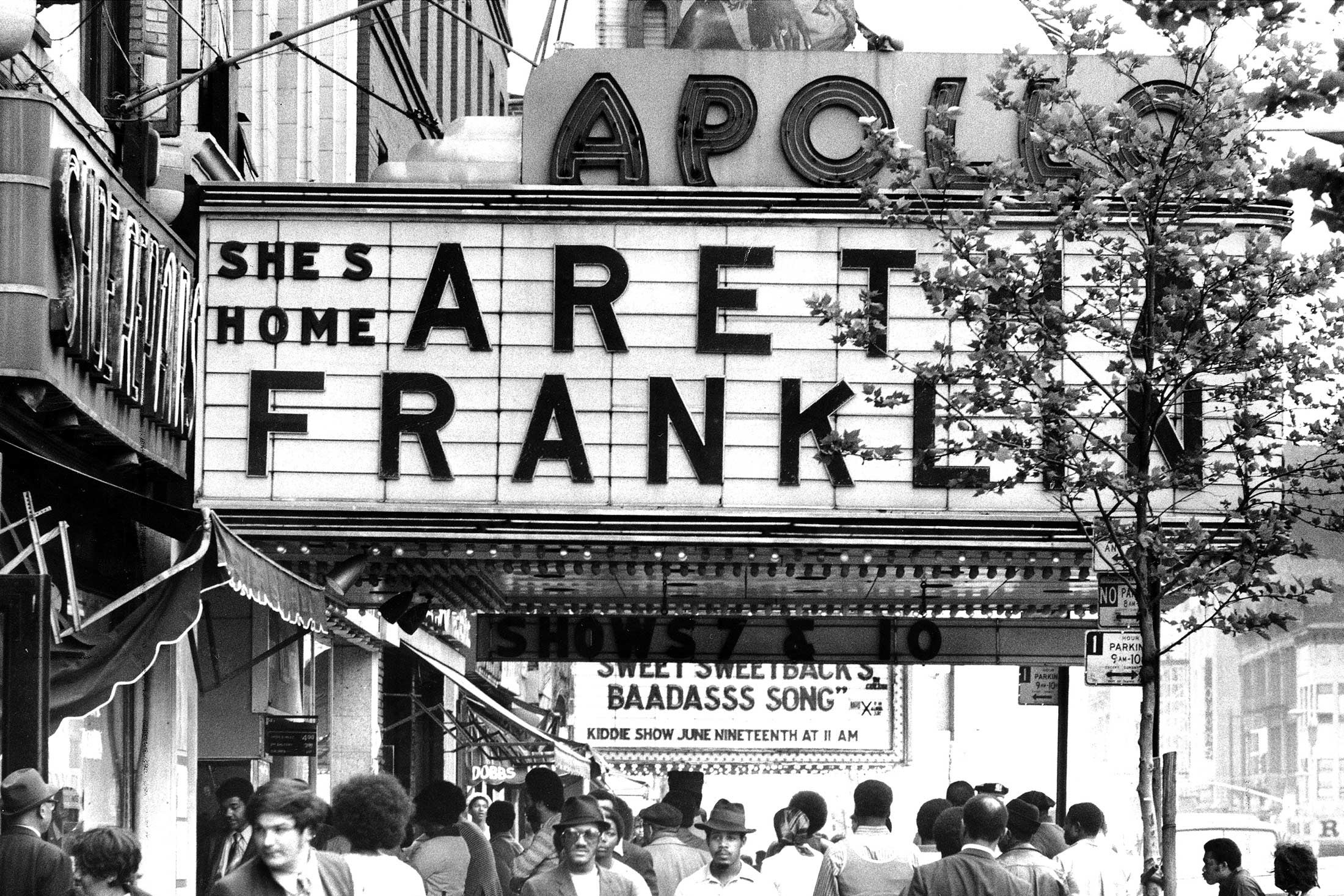 The Apollo Theater marquee in 1971, reading "She's Home: Aretha Franklin."