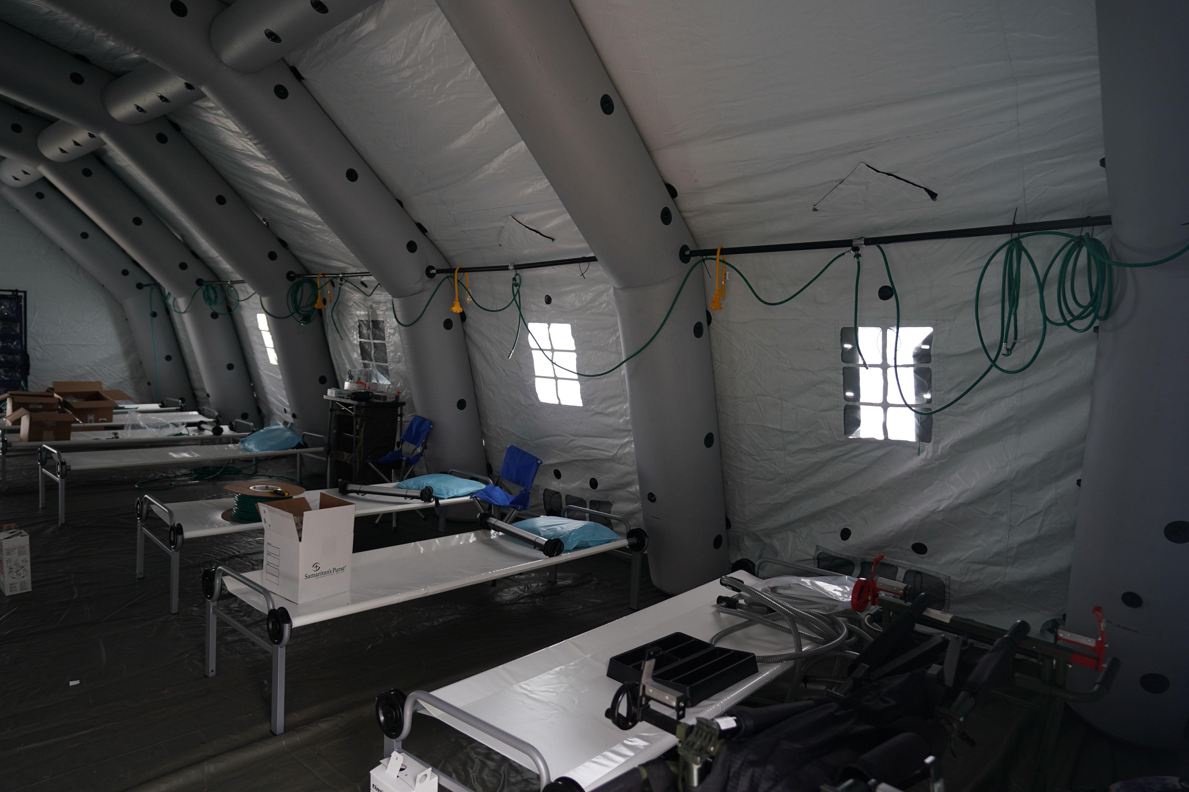 Beds are lined up in a tent as volunteers from the International Christian relief organization Samaritans Purse set up an Emergency Field Hospital for patients suffering from the coronavirus in March 2020.