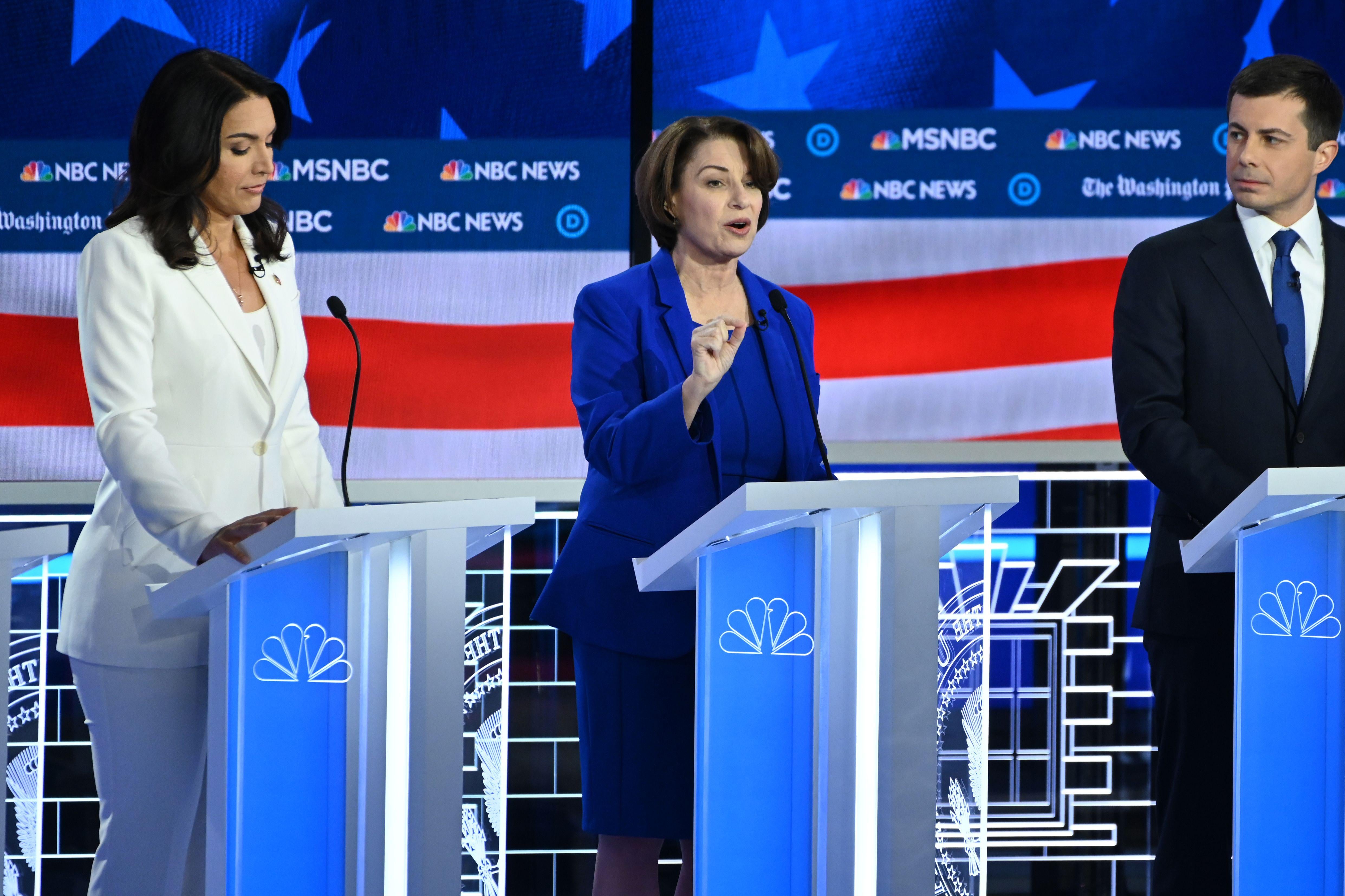 Democratic presidential hopefuls Representative for Hawaii Tulsi Gabbard (L), Minnesota Senator Amy Klobuchar (C) and Mayor of South Bend, Indiana, Pete Buttigieg (R) participate in the fifth Democratic primary debate of the 2020 presidential campaign season co-hosted by MSNBC and The Washington Post at Tyler Perry Studios in Atlanta, Georgia on November 20, 2019. (Photo by SAUL LOEB / AFP) (Photo by SAUL LOEB/AFP via Getty Images)