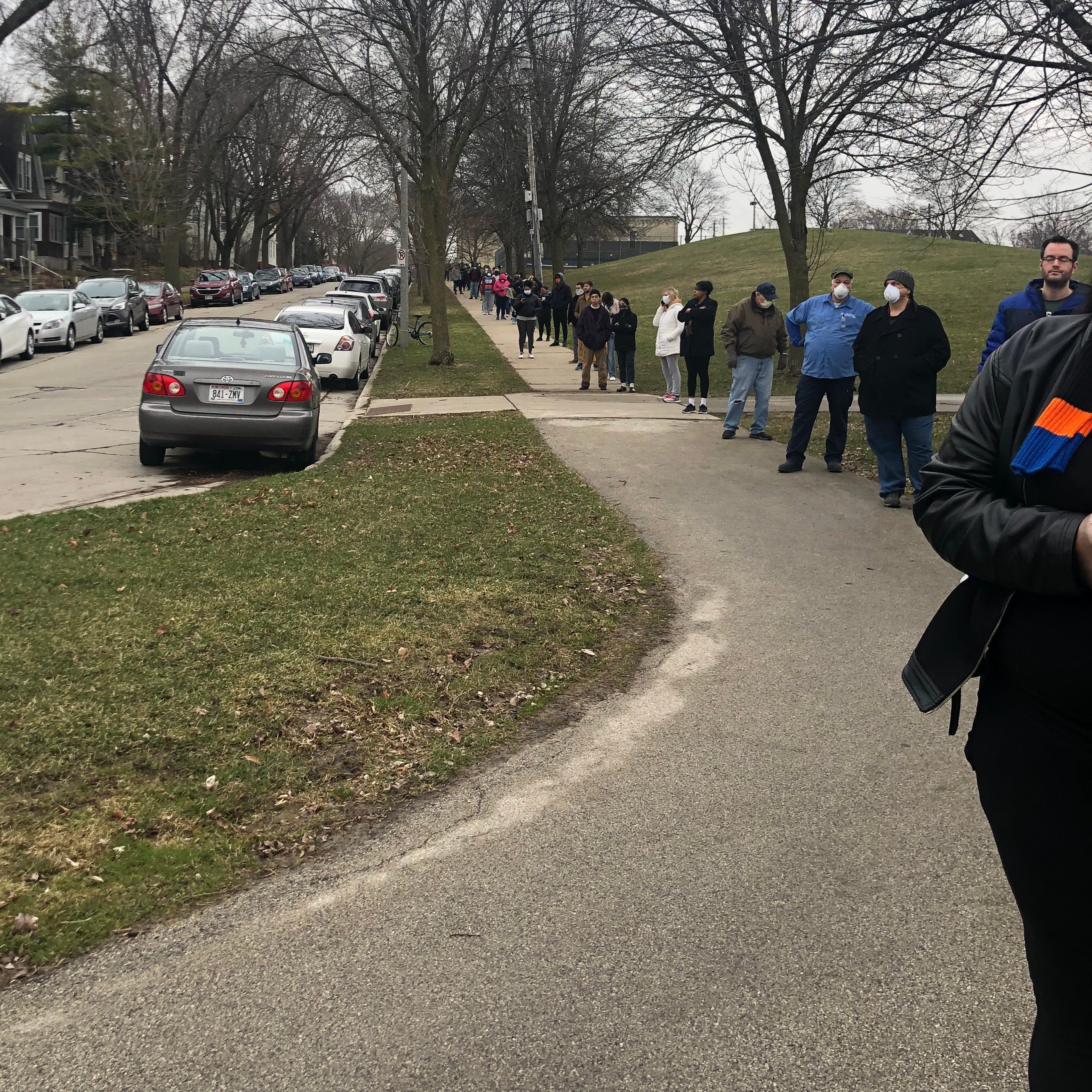 A long line of people stretches down a street.