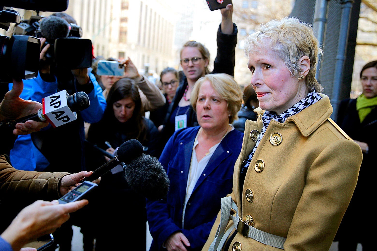 E. Jean Carroll talks to reporters outside of a courthouse.