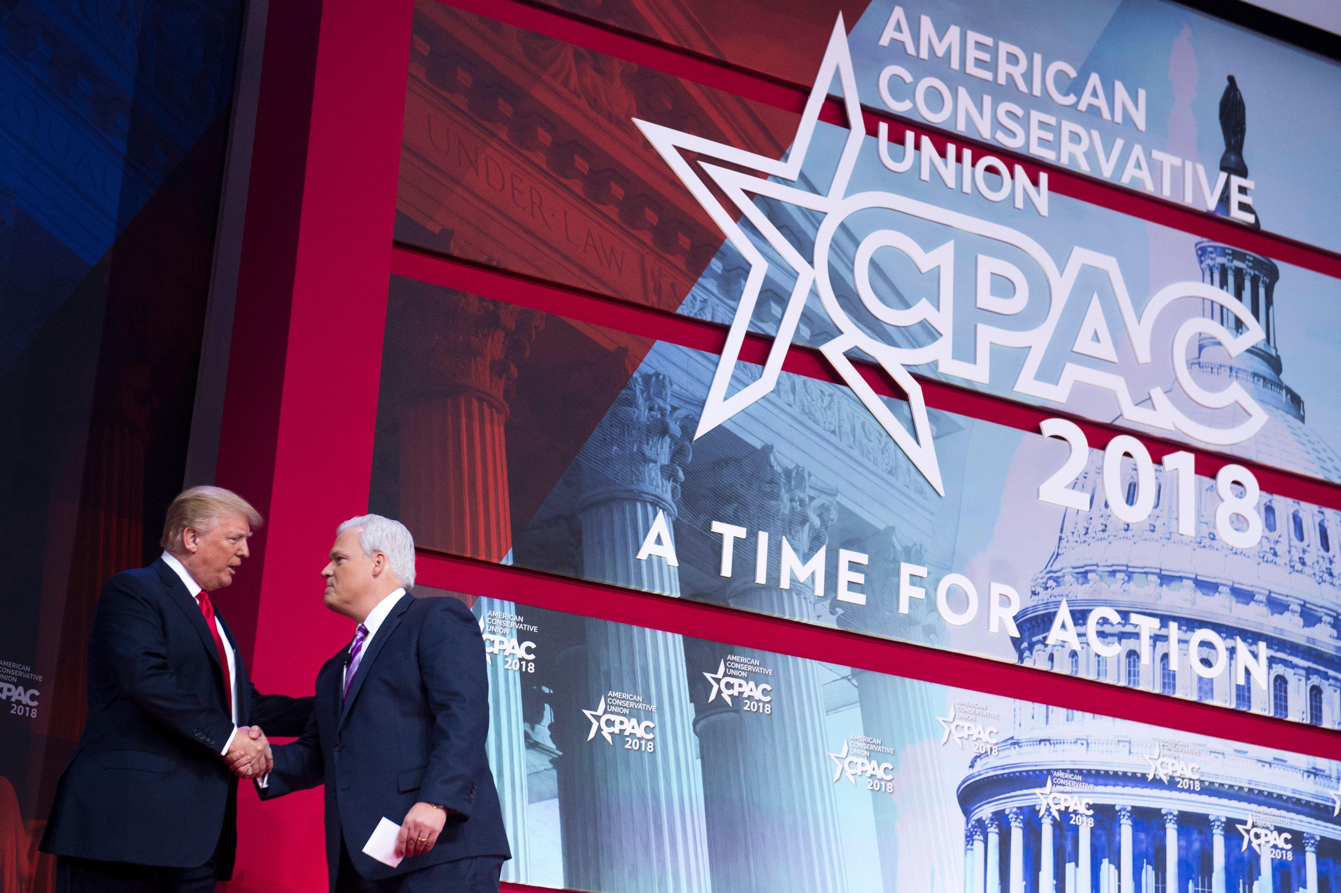 US President Donald Trump shakes hands with Matt Schlapp, chairman of the American Conservative Union, during the 2018 Conservative Political Action Conference (CPAC) at National Harbor in Oxon Hill, Maryland, February 23, 2018. / AFP PHOTO / SAUL LOEB        (Photo credit should read SAUL LOEB/AFP/Getty Images)