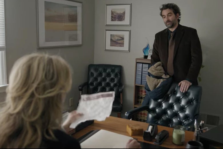 Bill stands in front of his lawyer's desk.