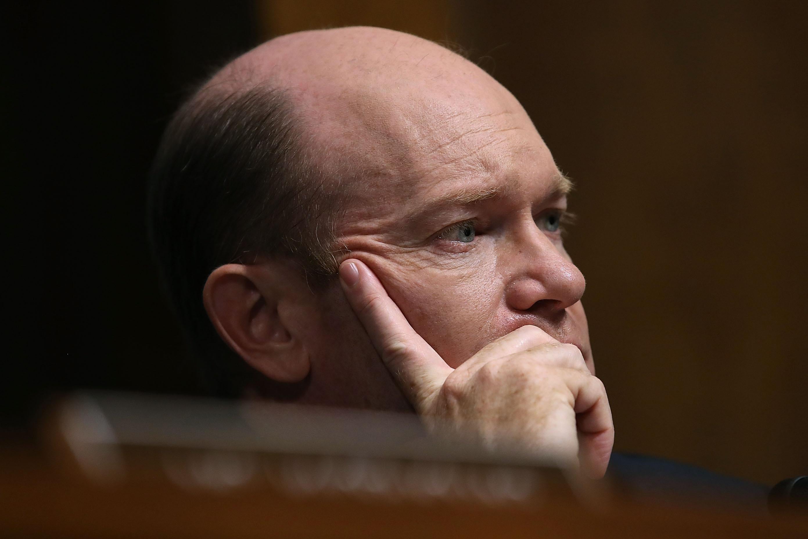 Sen. Chris Coons listens