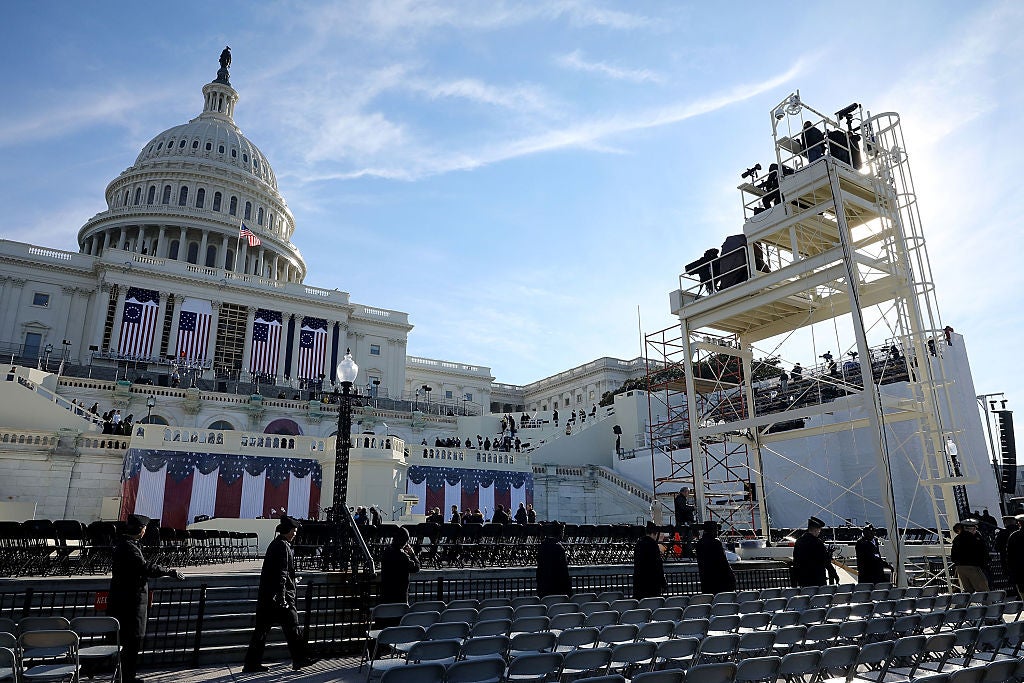 Workers install scaffolding and seats outside the U.S. Capitol building.