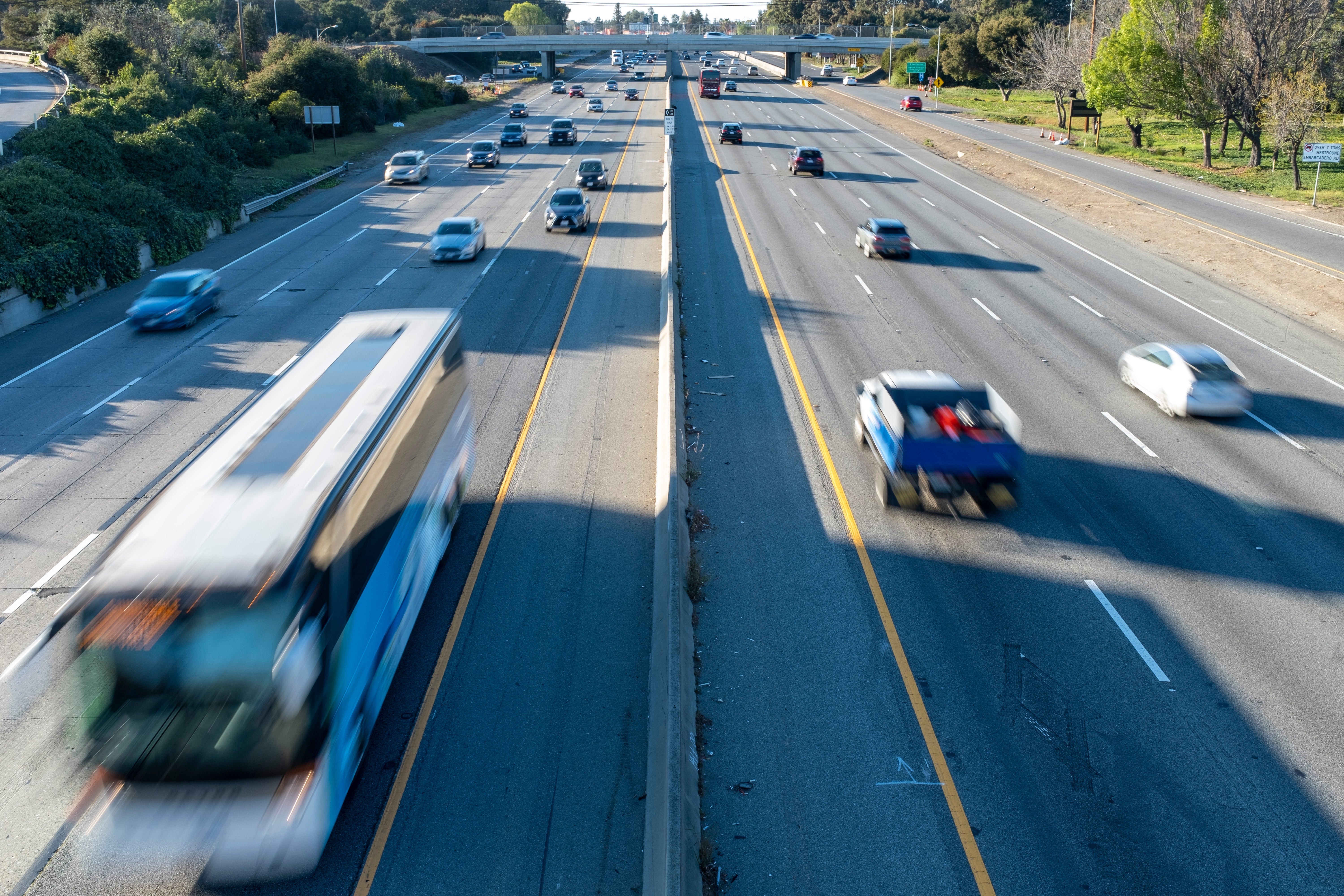 Commuters in Palo Alto, California, driving on a highway on a sunny day.