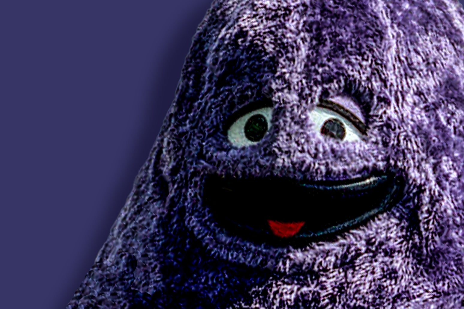 A close-up of the purple McDonald's character, who smiles, tongue out, against a purple background.
