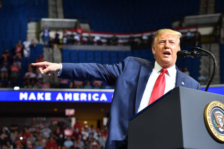 Trump pointing while on stage at a campaign rally
