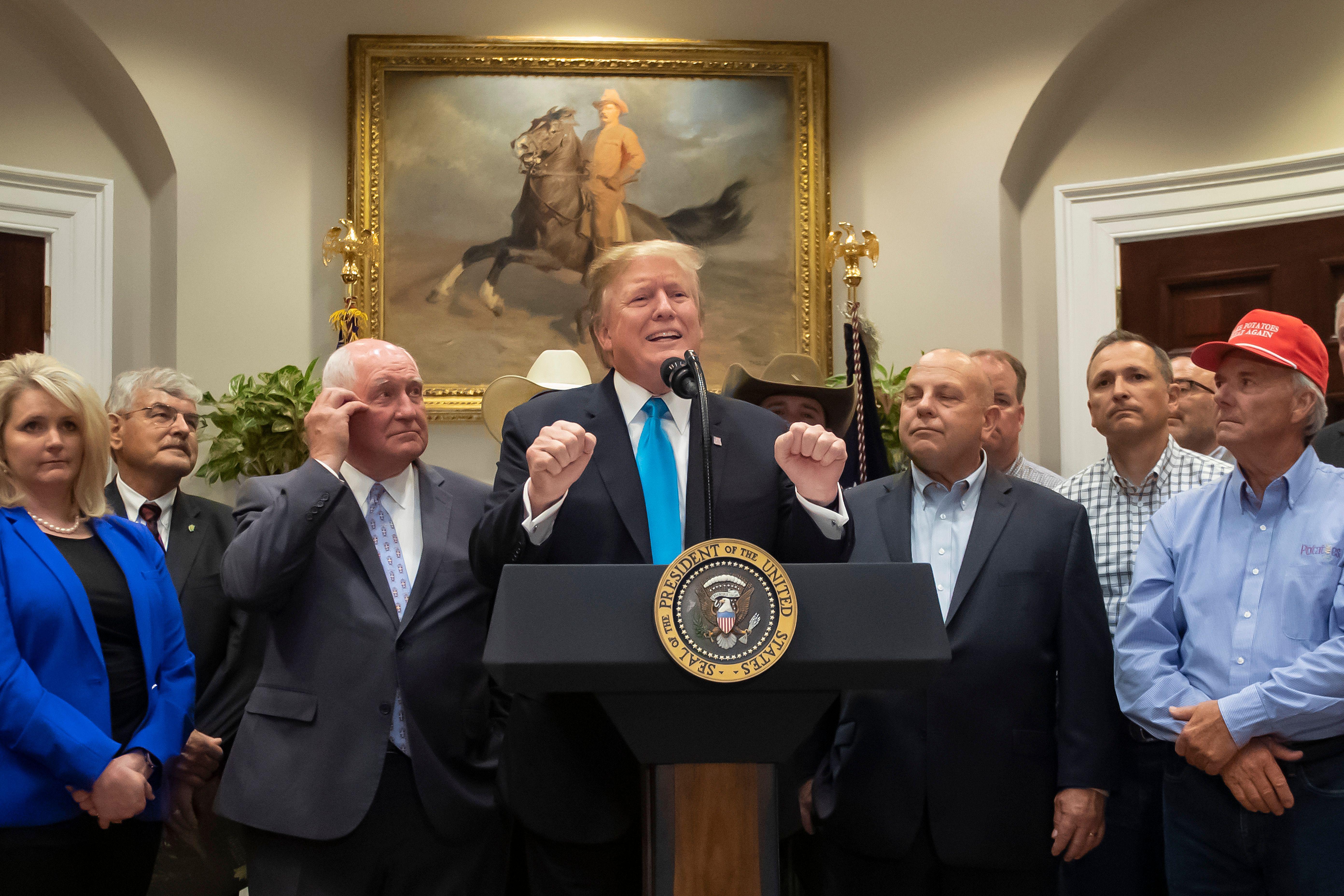 President Donald Trump and some farmers he's bailing out, in Washington.