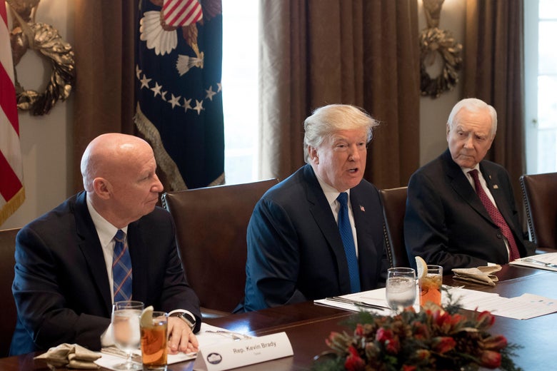 US President Donald Trump speaks about tax reform legislation during a lunch with lawmakers working on the tax reform conference committee, including Senator Orrin Hatch (R), Republican of Utah, and Representative Kevin Brady (L), Republican of Texas, in the Cabinet Room at the White House in Washington, DC, December 13, 2017. / AFP PHOTO / SAUL LOEB        (Photo credit should read SAUL LOEB/AFP/Getty Images)
