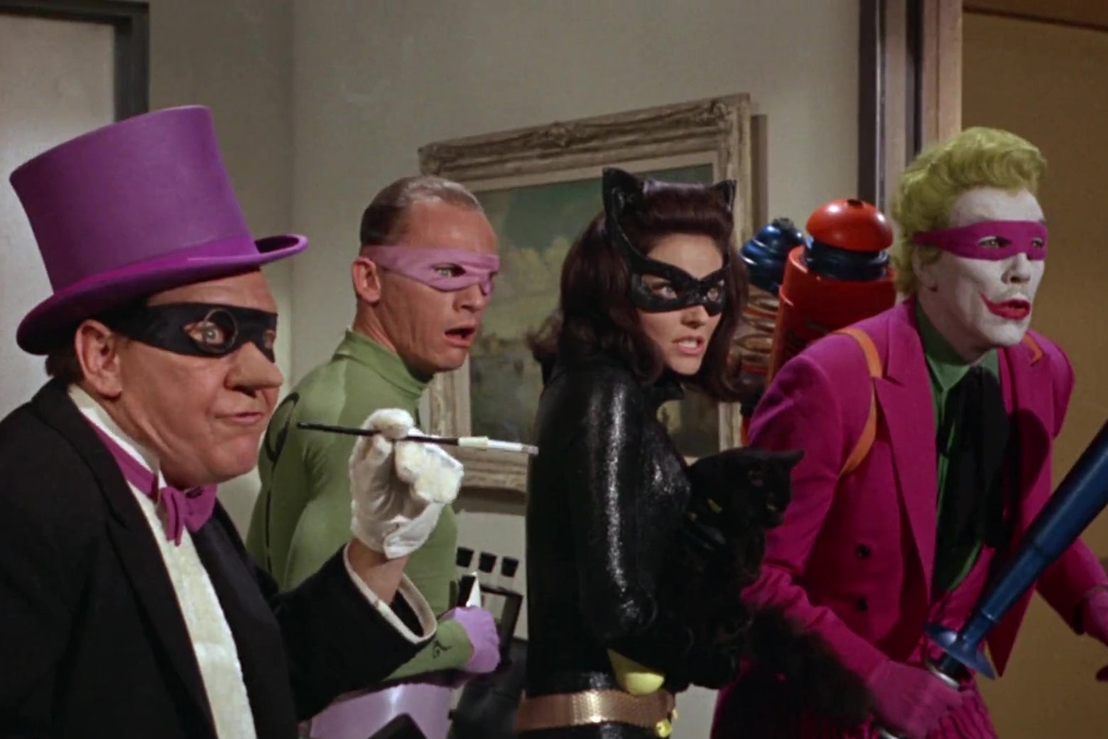 The Penguin, the Riddler, Catwoman, and the Joker looking shocked in a still from the 1966 Batman movie.