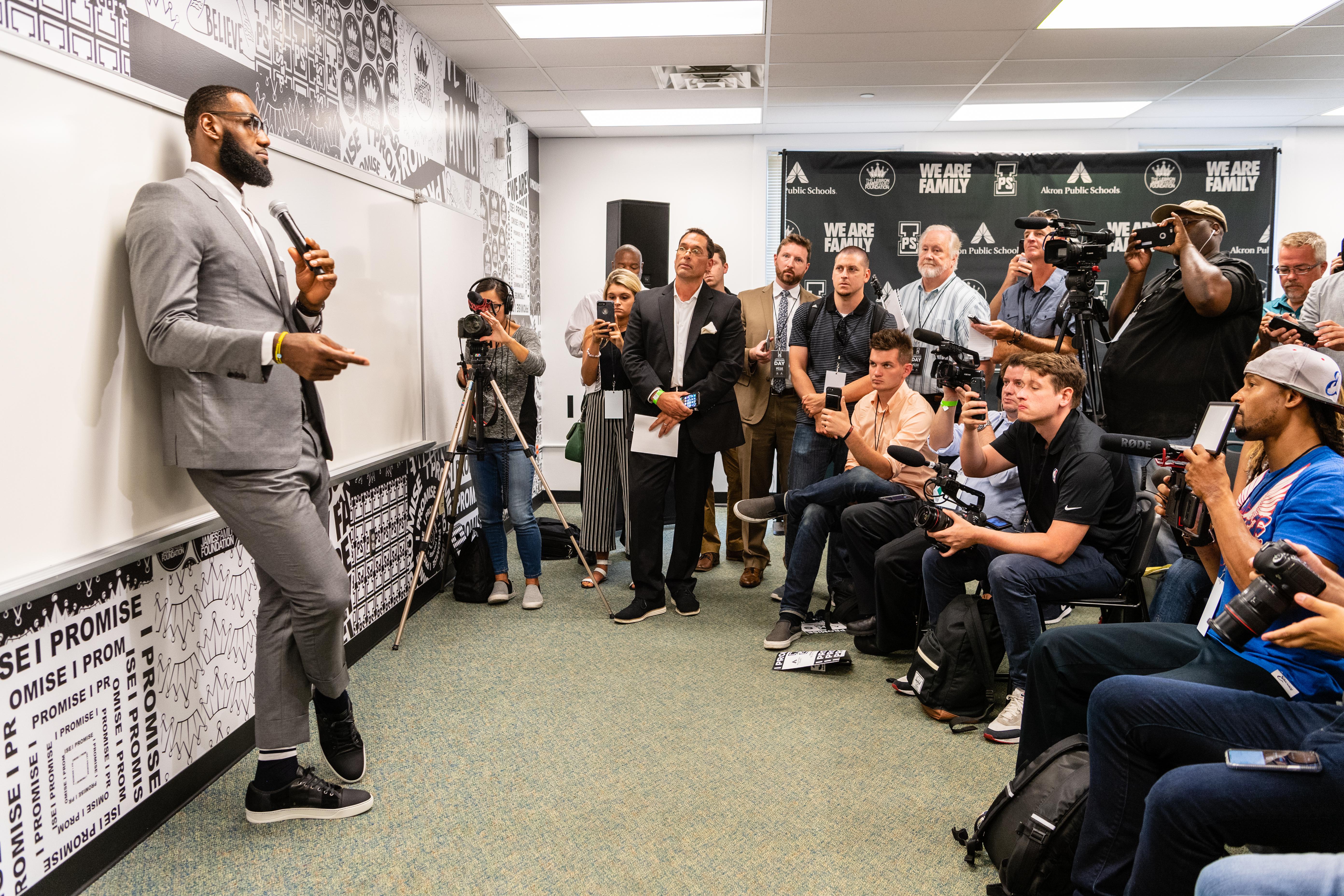 In a classroom at I Promise School, LeBron James speaks before a scrum of reporters.