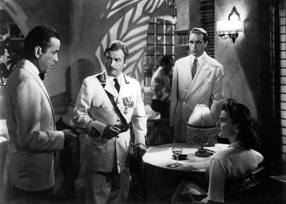 Humphrey Bogart addresses Claude Rains, Paul Henreid, and Ingrid Bergman in Casablanca.