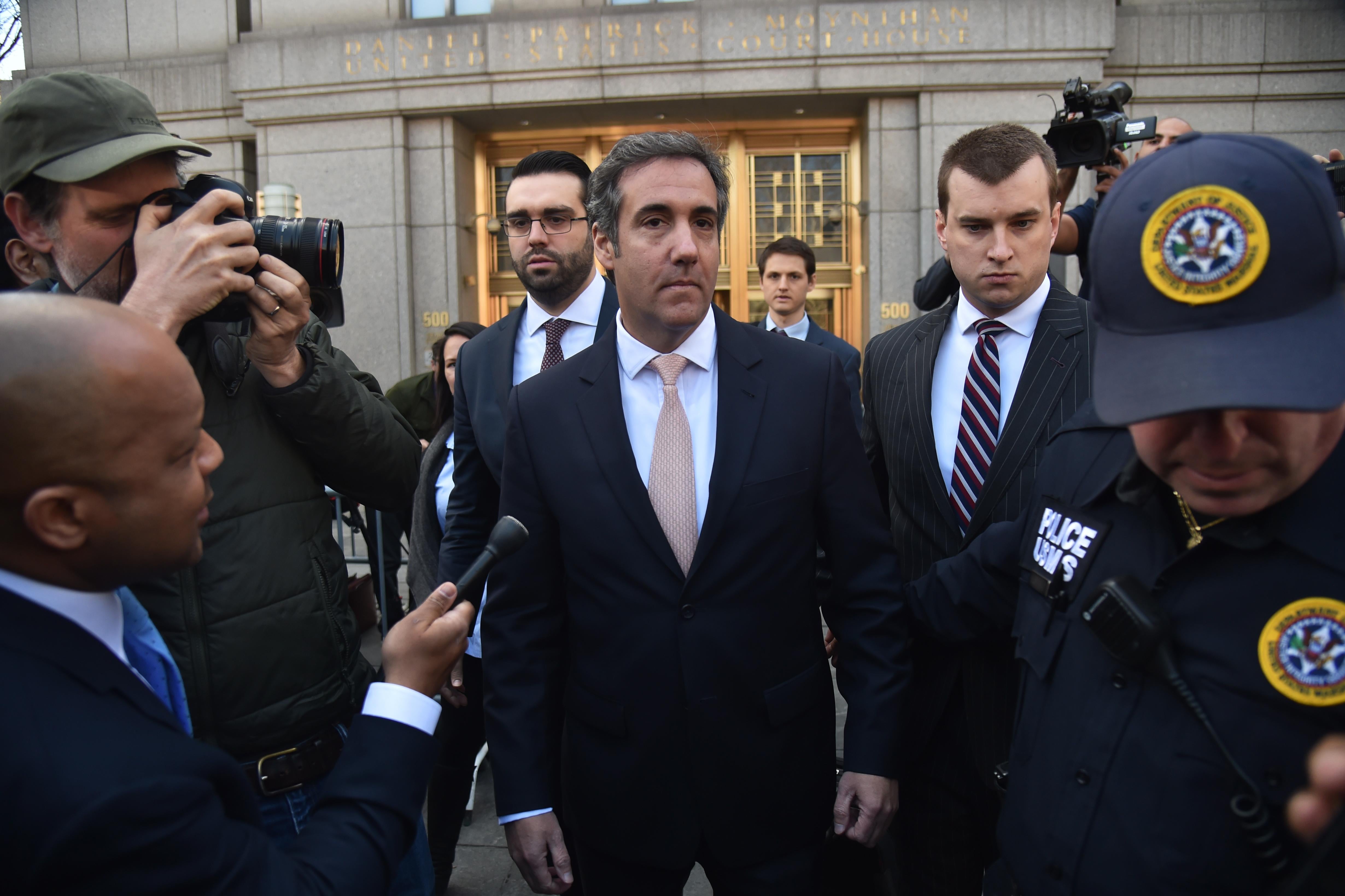 US President Donald Trump's personal lawyer Michael Cohen(C) leaves the US Courthouse in New York on April 26, 2018. - US President Donald Trump acknowledged on Thursday that his personal lawyer, Michael Cohen, represented him in a 'deal' involving porn star Stormy Daniels. Trump had previously denied knowledge of a $130,000 payment Cohen made to Daniels that she claims was to prevent her from talking about their alleged 2006 affair.Trump, in a wide-ranging telephone interview with 'Fox and Friends,' admitted for the first time that Cohen represented him in a 'deal' with Daniels, who has filed a lawsuit seeking to have the 'hush agreement' negotiated by Cohen thrown out. (Photo by HECTOR RETAMAL / AFP)        (Photo credit should read HECTOR RETAMAL/AFP/Getty Images)