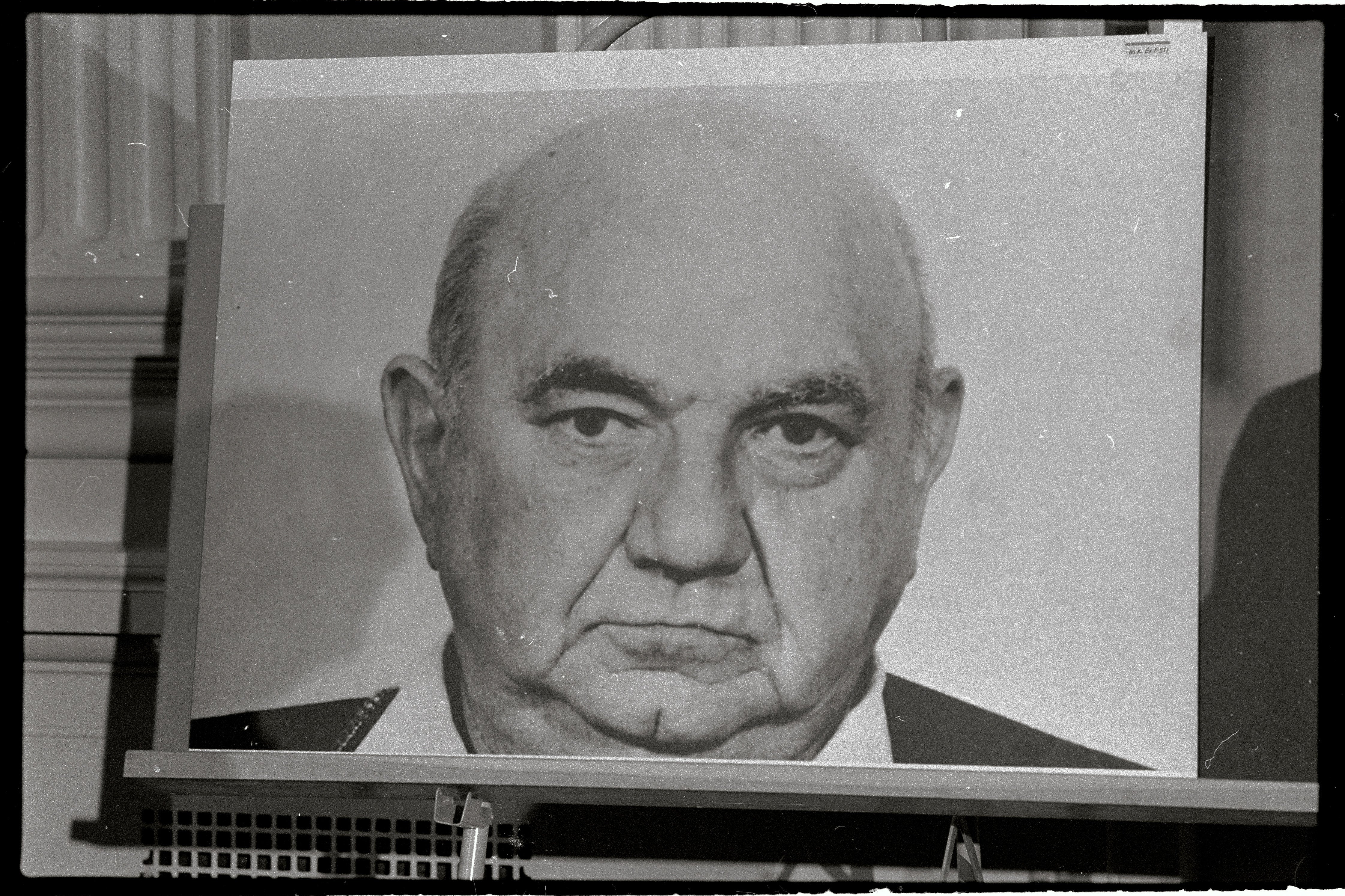 Trial portrait of an older, balding white man.