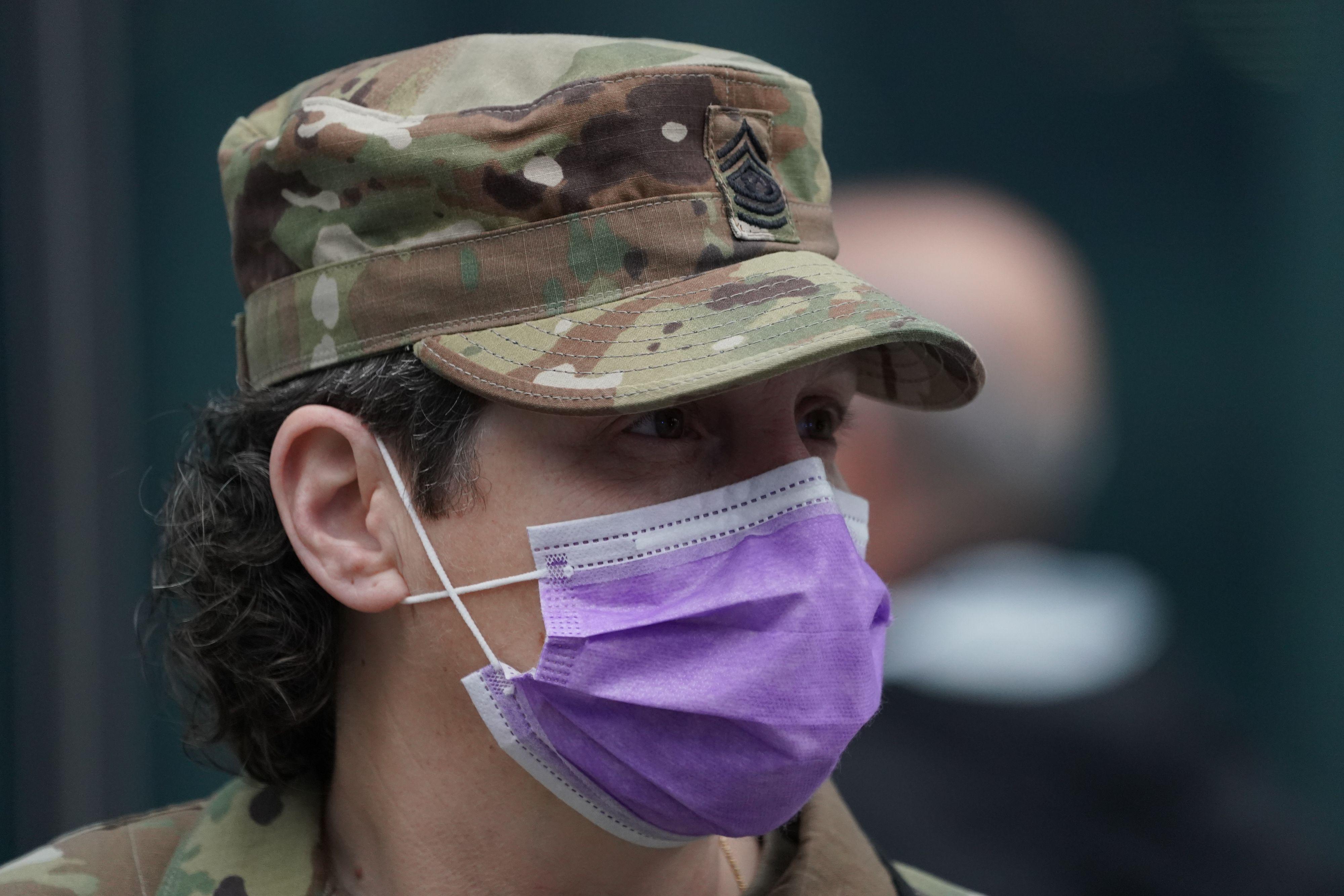 U.S. National Guard soldier wearing a purple facemask.