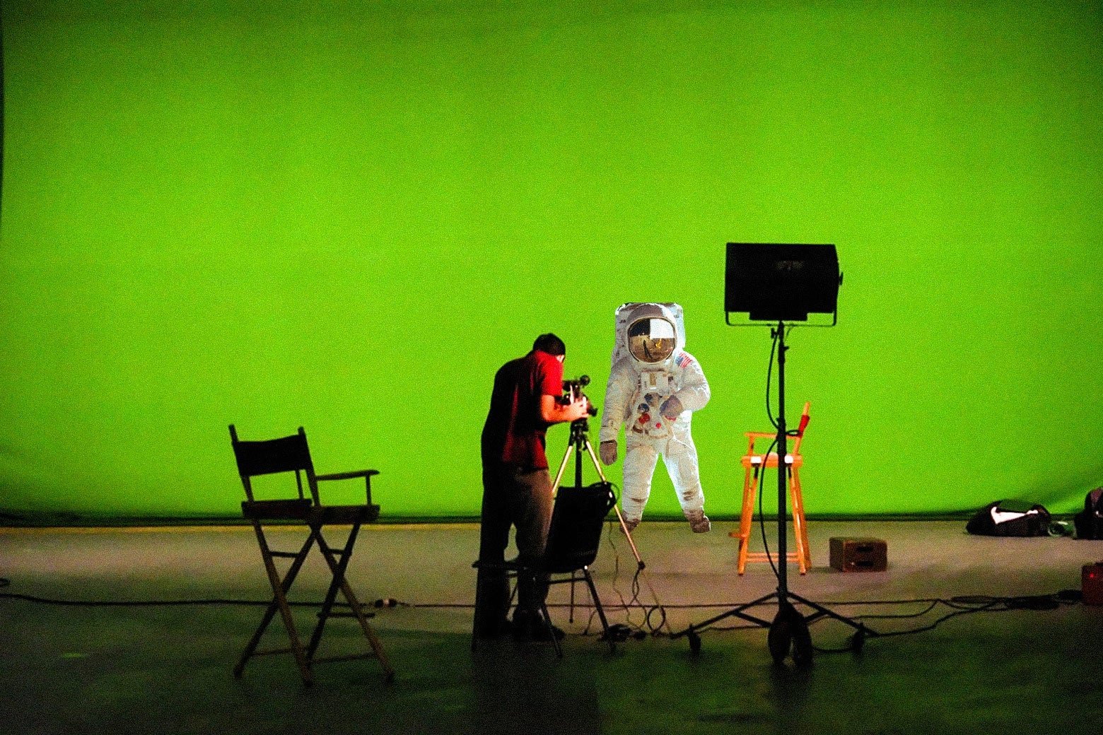 An astronaut standing on a green screen.