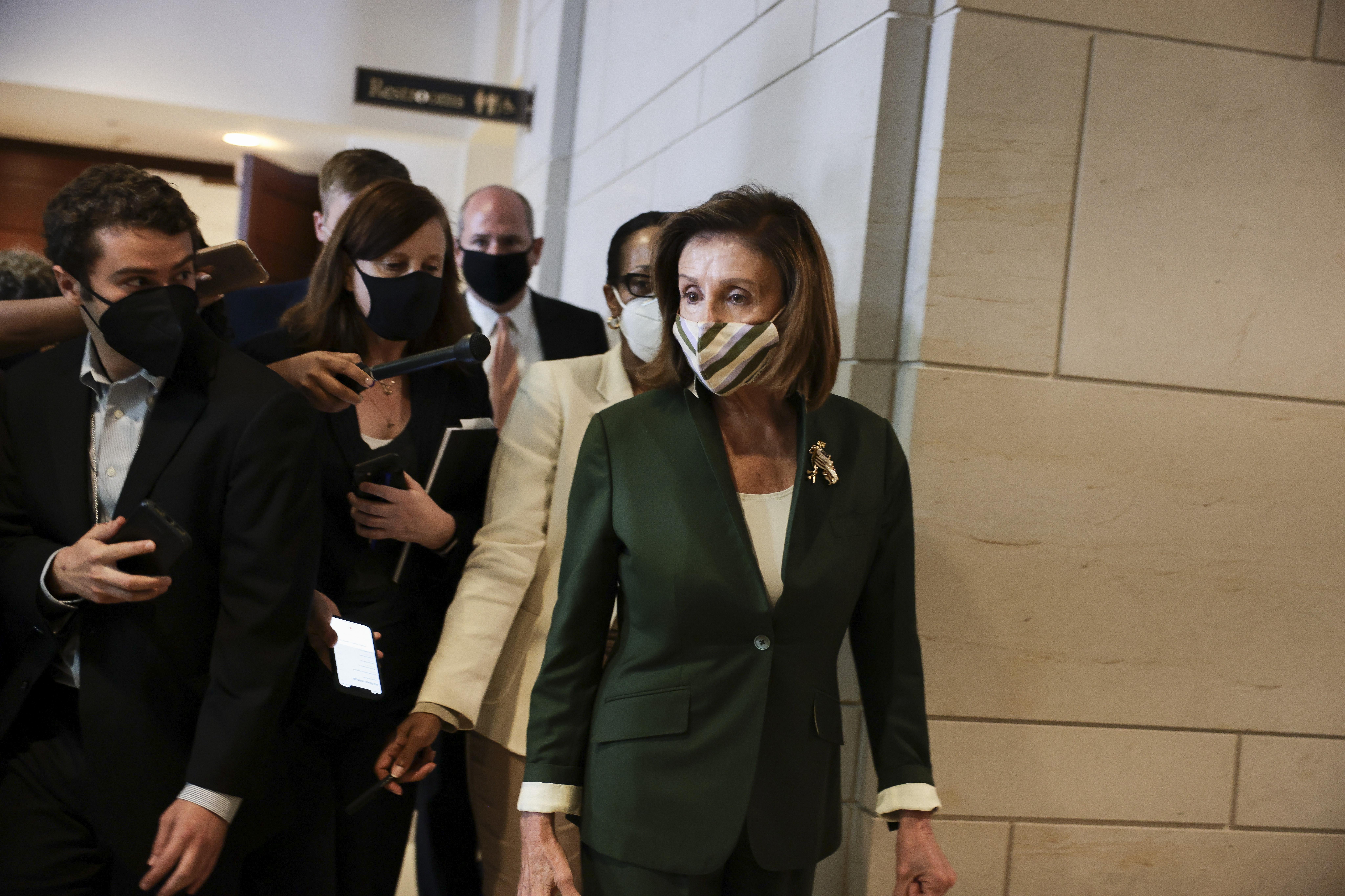 House Speaker Nancy Pelosi walking in the Capitol building, followed by reporters as she departs from a classified briefing held by U.S. Capitol Police Chief J. Thomas Manger to brief congressional leaders on the security preparations for a rally taking place on Capitol Hill.