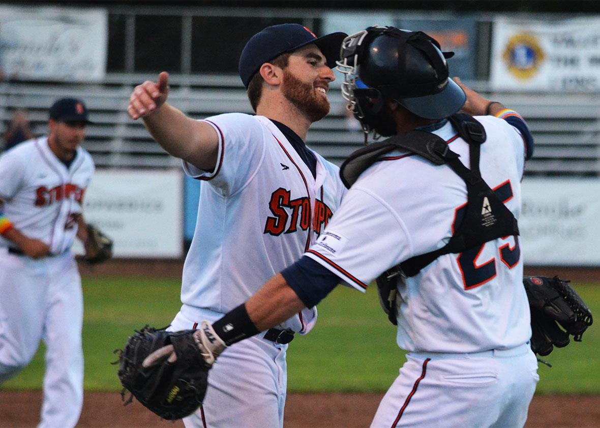 Sean Conroy hugs his catcher Isaac Wenrich.